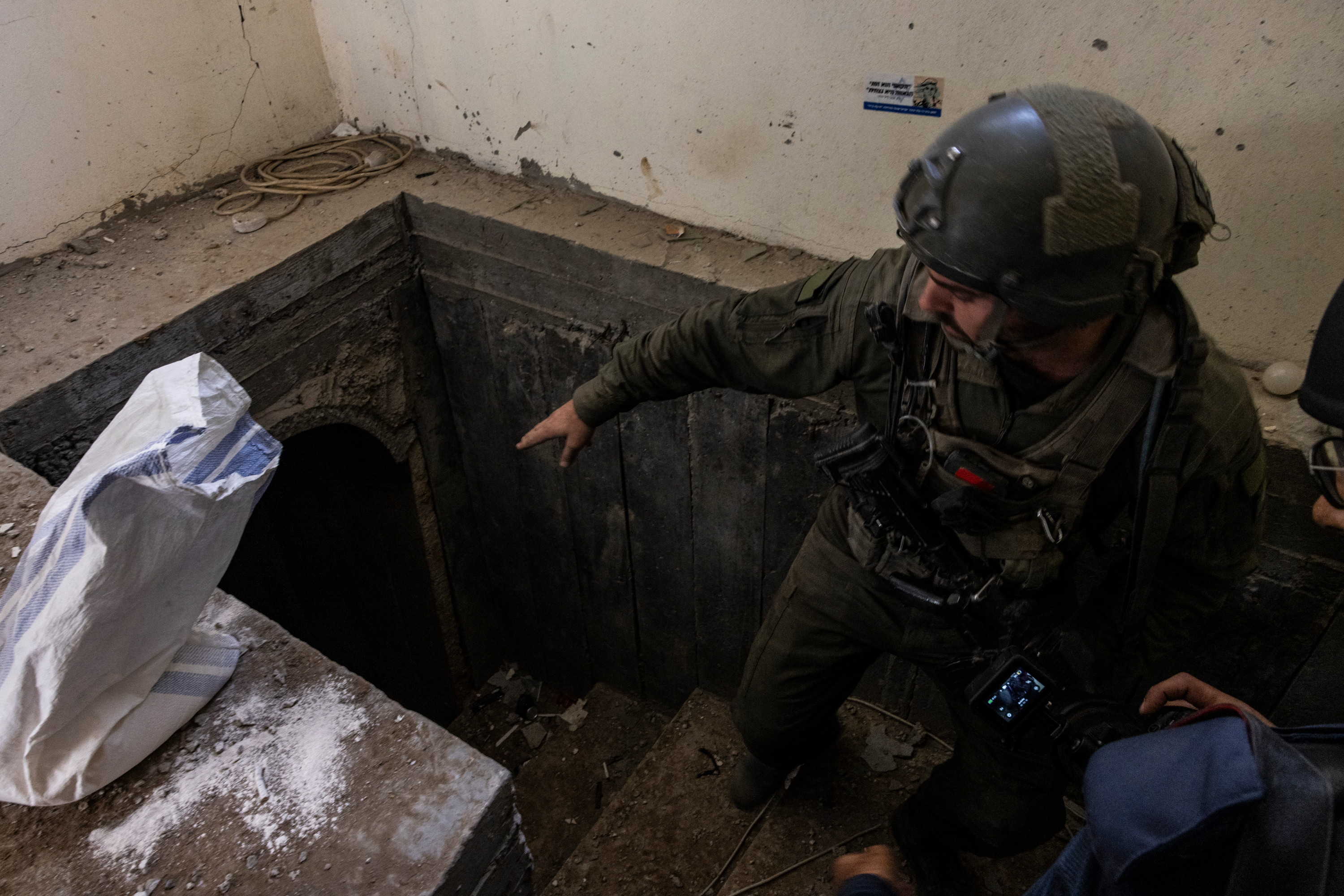 This picture taken during a media tour organized by the Israeli military on January 8, shows a soldier standing at the entrance of a tunnel in al-Bureij central Gaza.