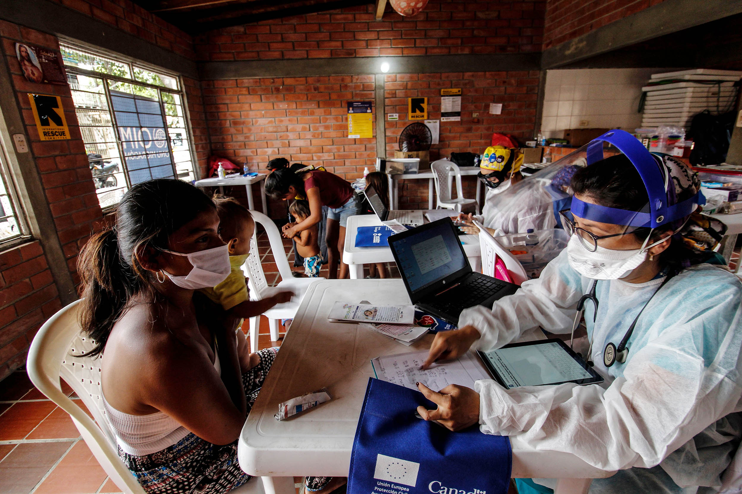 Staffers from Colombia's Secretary of Health check Venezuelan Yukpa indigenous ethnic group member, in Cucuta, Venezuela on July 9, amid the COVID-19 pandemic. 