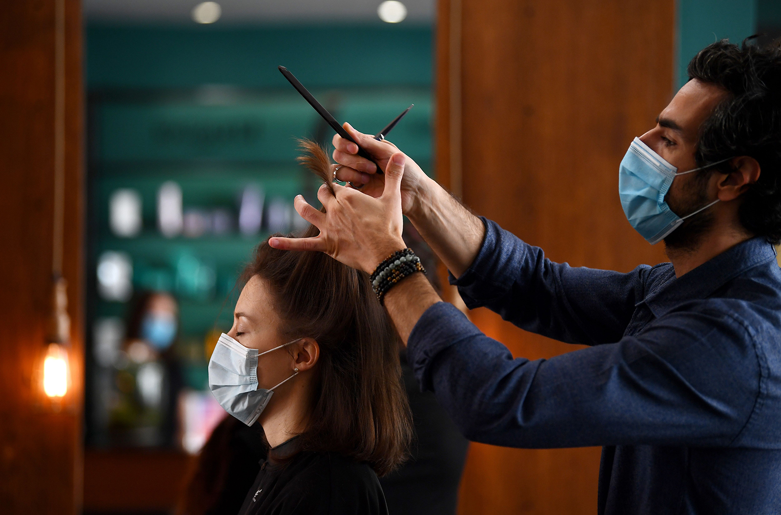 A nurse from the Pitie Salpetriere Hospital gets a haircut at the "Hovig Etoyan" salon on May 12, in Paris.