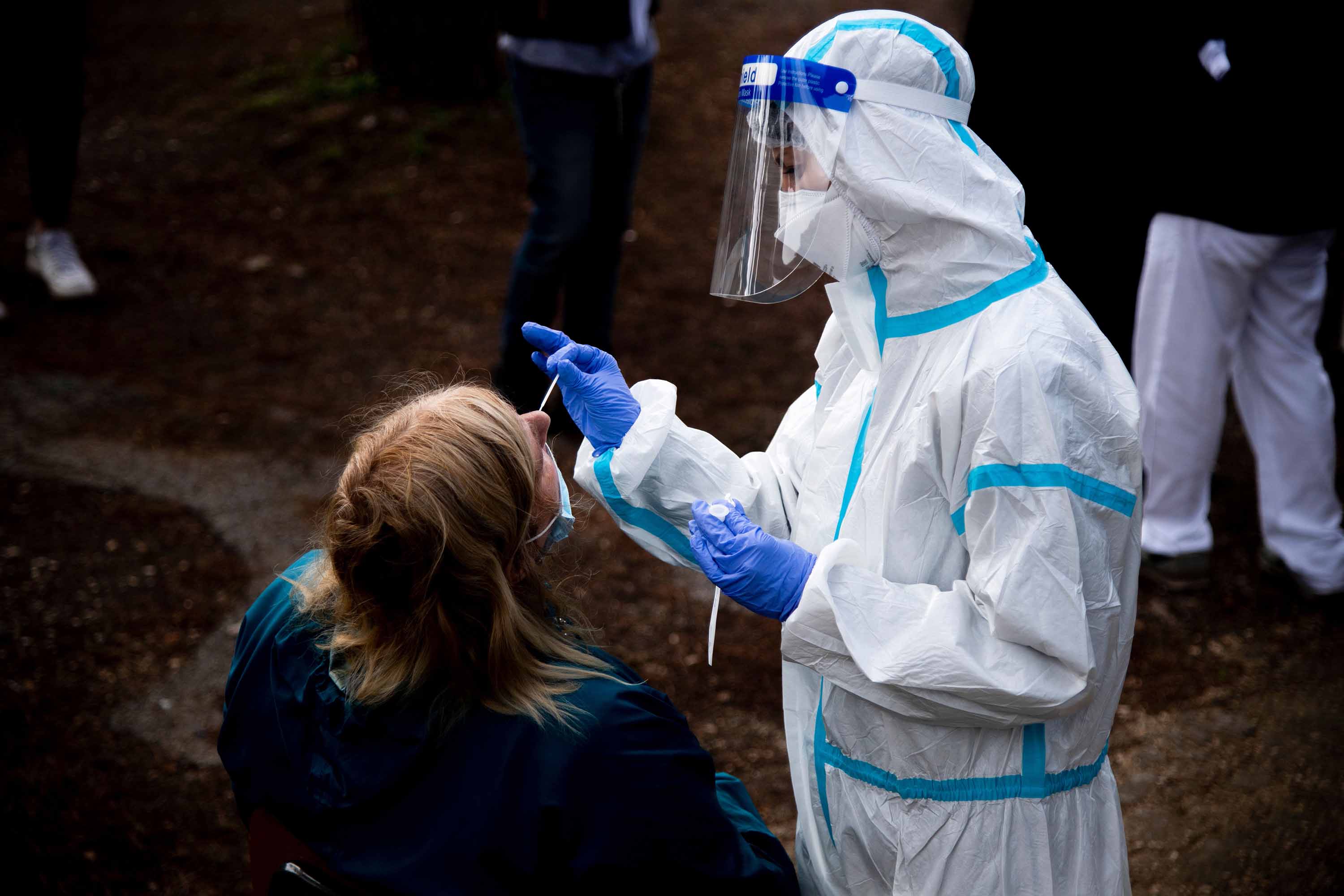 A woman undergoes a swab test for coronavirus at a drive-through testing site at a hospital in Rome, on October 12.