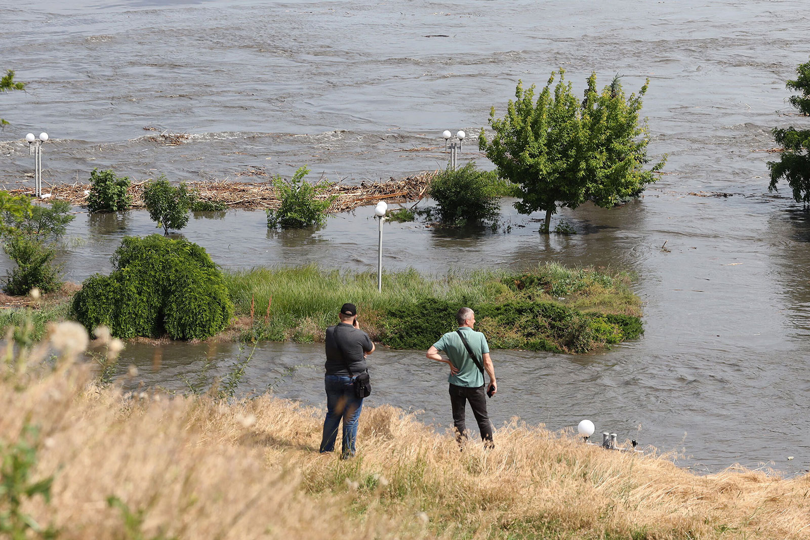 People look out over at a partially flooded area of Kherson, Ukraine.