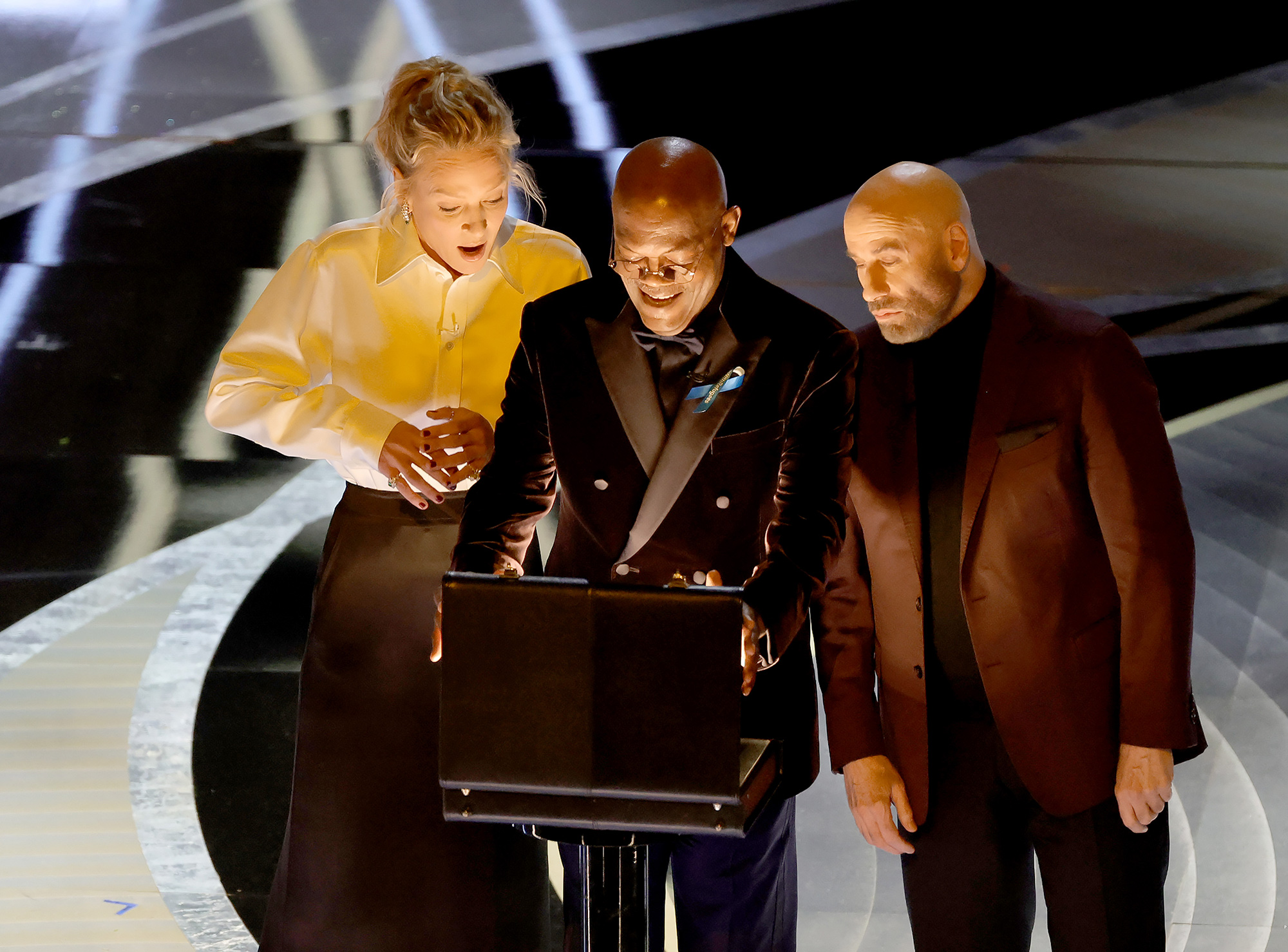 From left: Uma Thurman, Samuel L. Jackson, and John Travolta speak onstage during the 94th Annual Academy Awards.