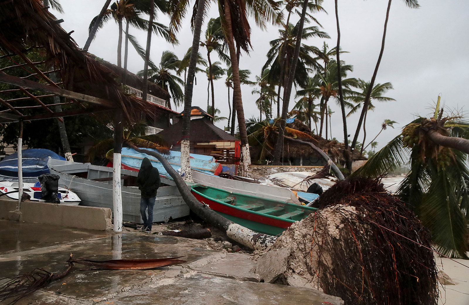 A person walks amidst debris on the seashore in the aftermath of Hurricane Fiona in Punta Cana, Dominican Republic on September 19. 