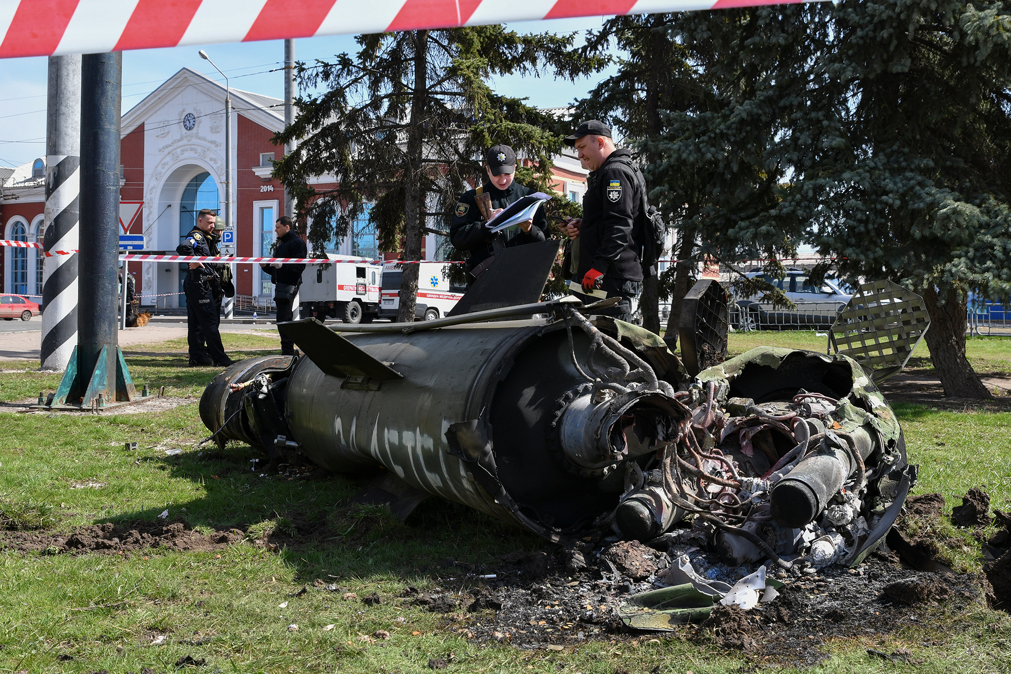 Ukrainian servicemen stand next to fragments of a missile outside the railway station in Kramatorsk, Ukraine, on Friday, April 8. 