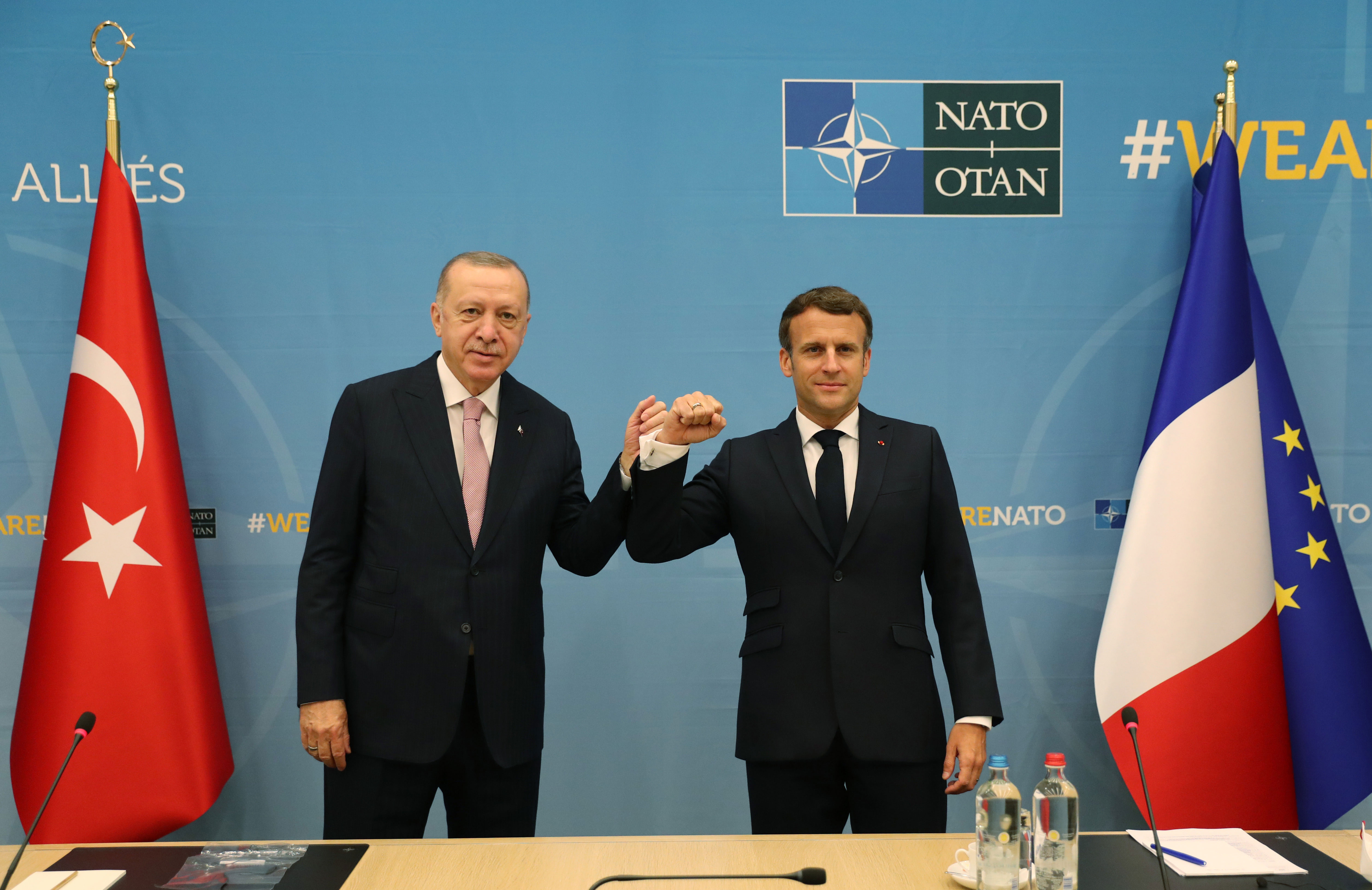 Turkish President Recep Tayyip Erdogan, left, greets French President Emmanuel Macron during their meeting within the NATO summit in Brussels, Belgium, on June 14.