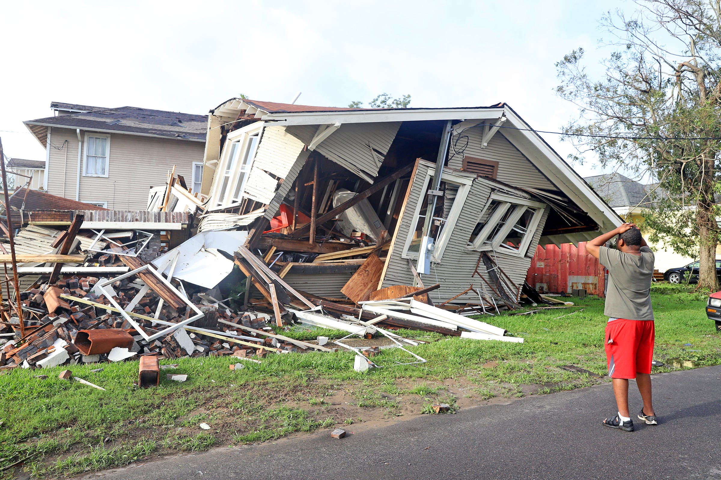 Dartanian Stovall looks at the house that collapsed with him inside during the height of Hurricane Ida in New Orleans.