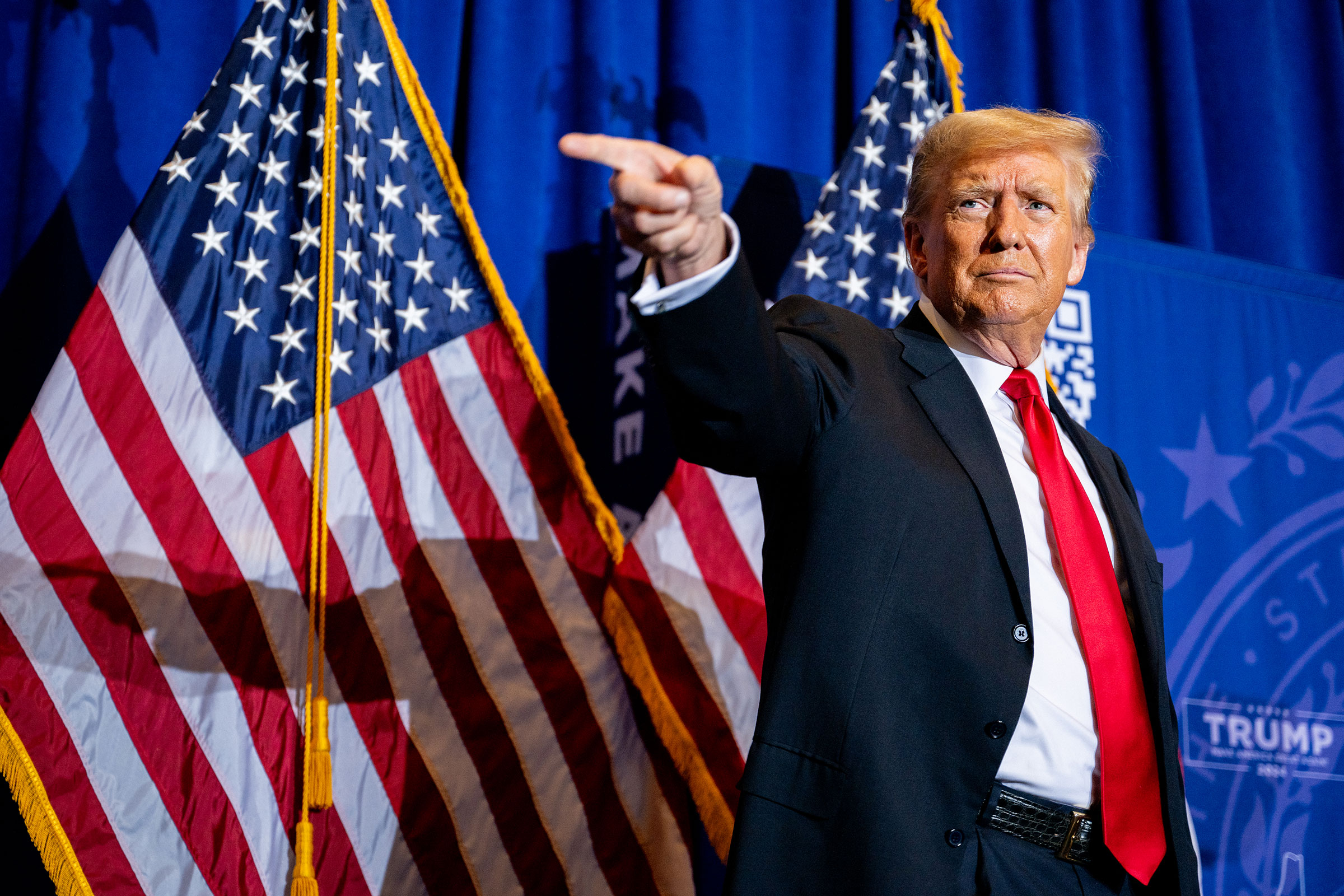 Former President Donald Trump points to supporters at the conclusion of a campaign rally at the Atkinson Country Club on January 16, 2024 in Atkinson, New Hampshire.