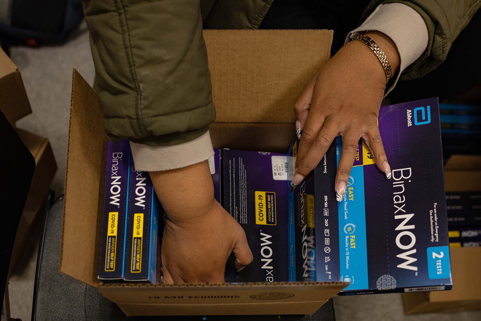 Workers distribute free rapid at-home Covid-19 test kits at a vaccine clinic in Philadelphia, last week. 