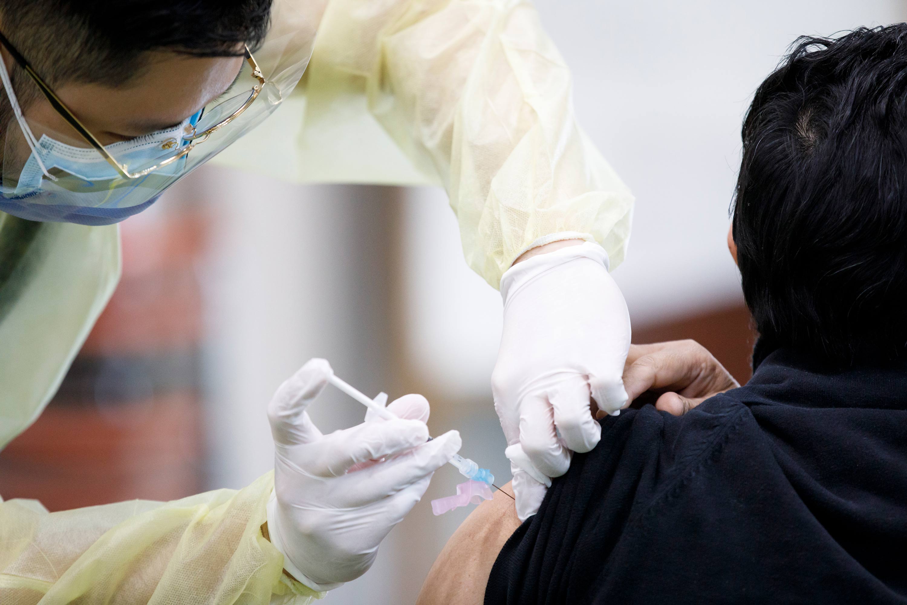 A healthcare worker administers a Moderna COVID-19 vaccination at Toronto and Region Islamic Congregation Islamic Centre on April 1 in Toronto, Canada. 