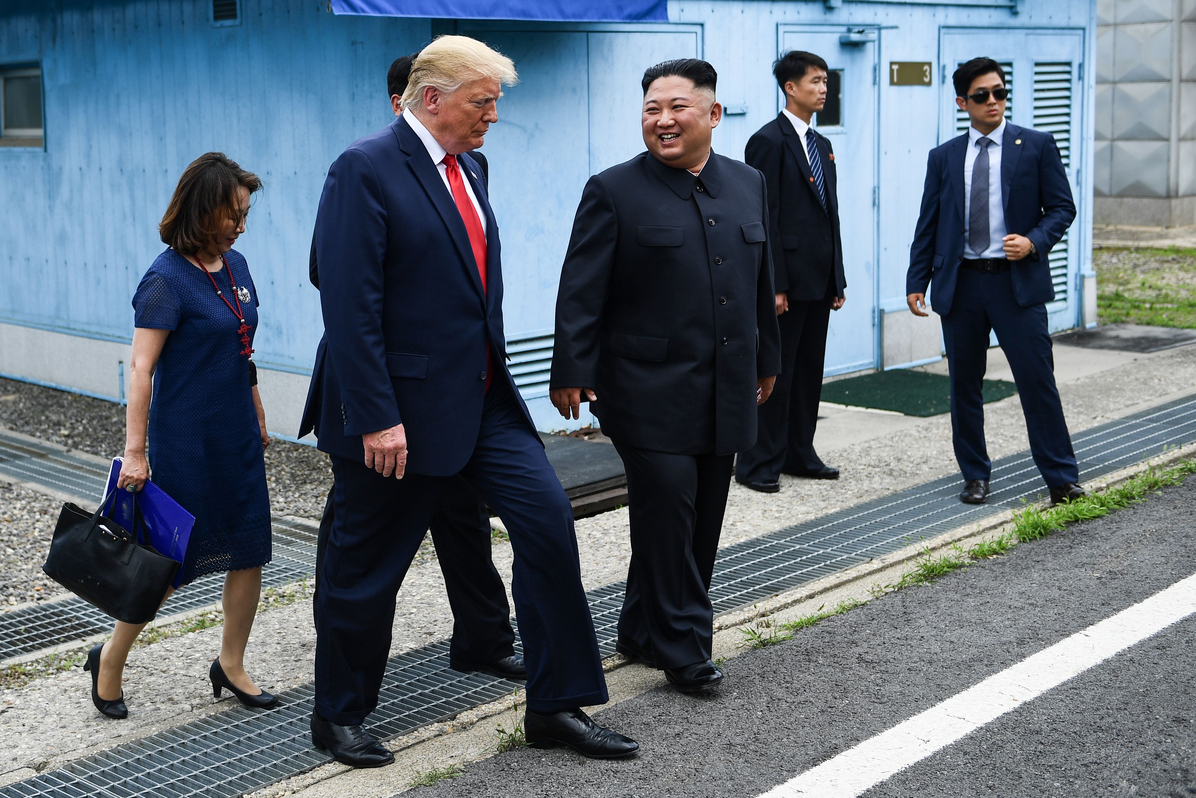 North Korea's leader Kim Jong Un and US President Donald Trump walk together into North Korean territory at the DMZ.