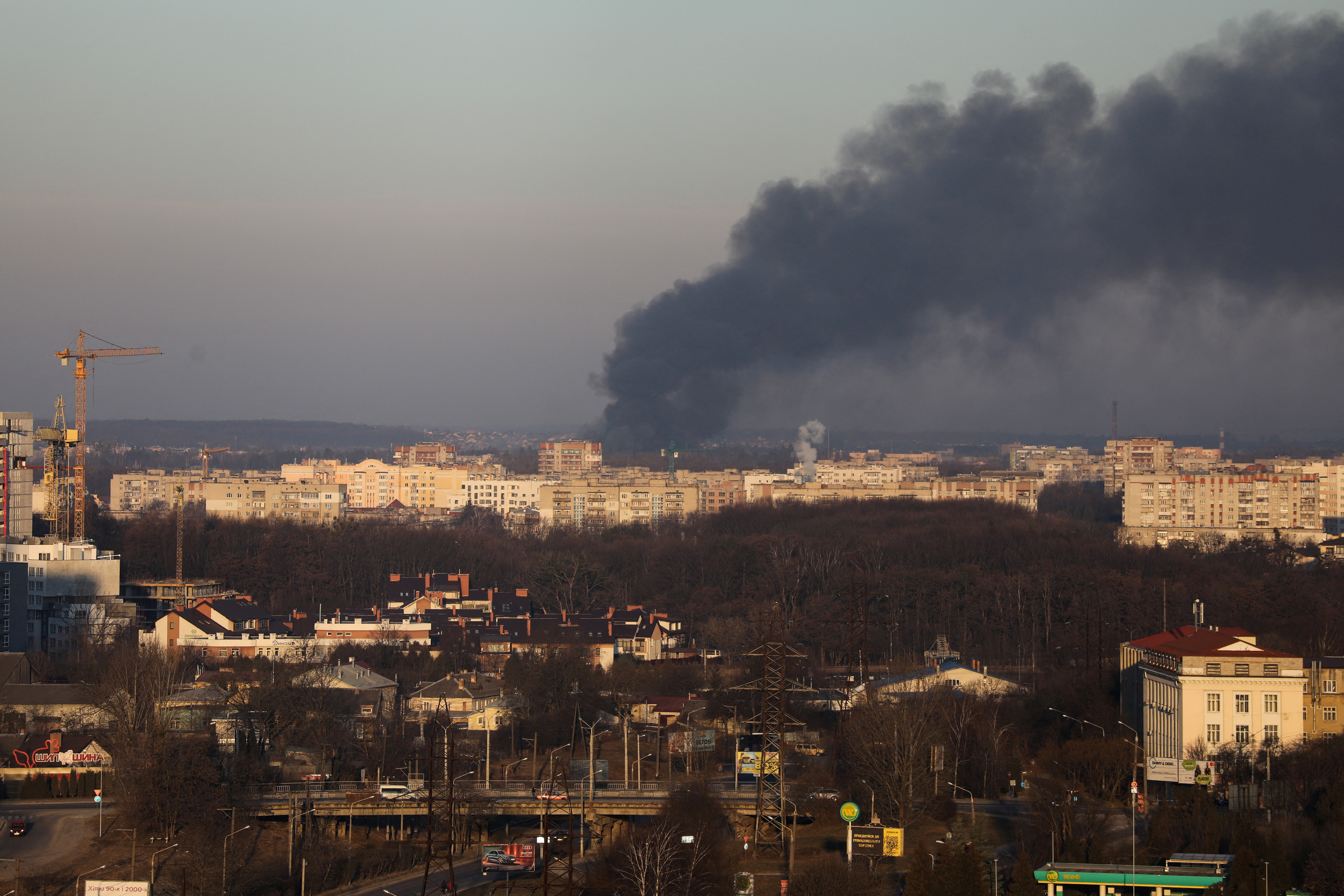 Smoke rises above buildings near the airport in Lviv, Ukraine, on March 18.