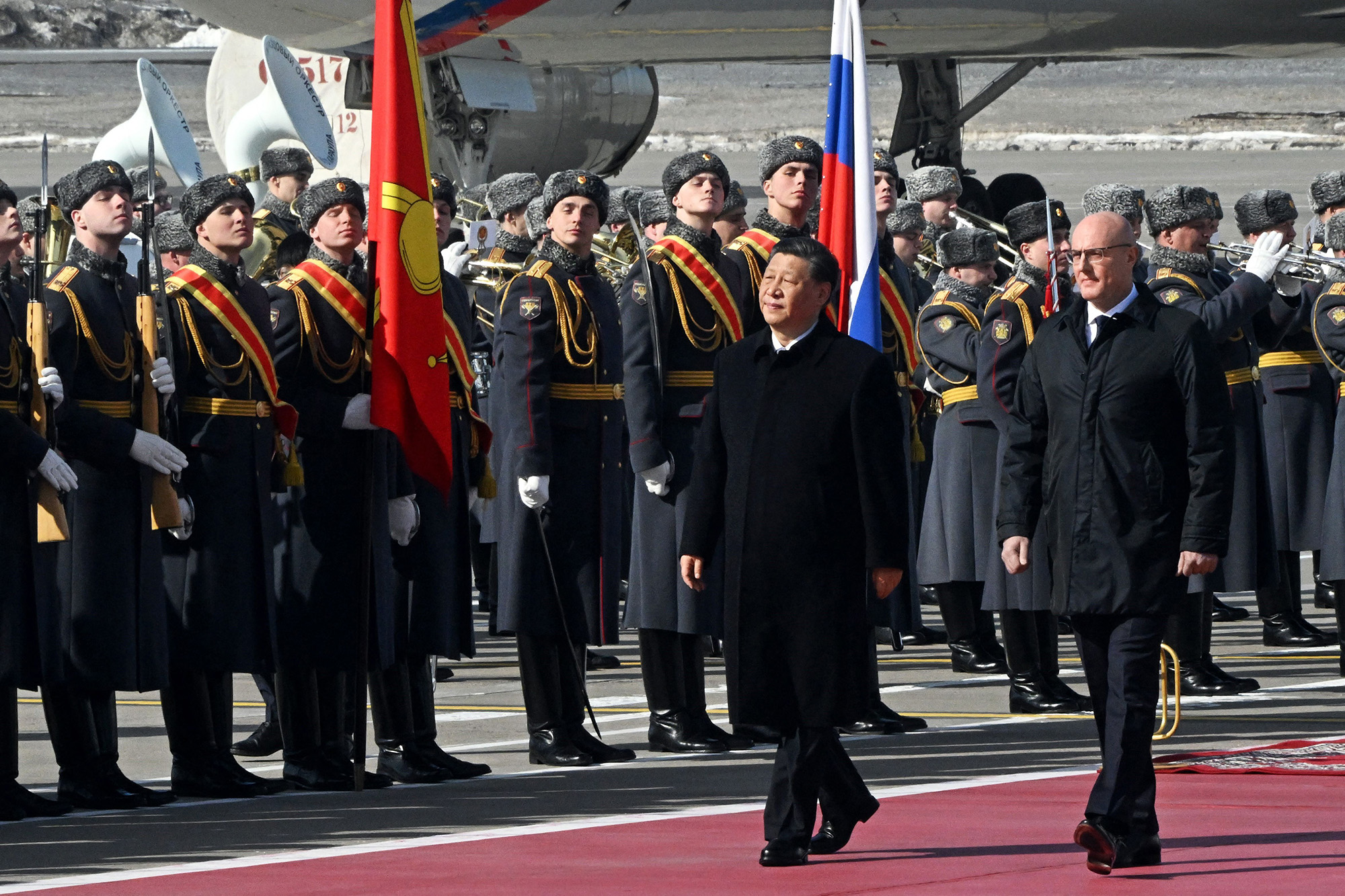 China's President Xi Jinping, center, accompanied by Russian Deputy Prime Minister Dmitry Chernyshenko, walks past honour guards during a welcoming ceremony at Vnukovo airport in Moscow, Russia, on March 20