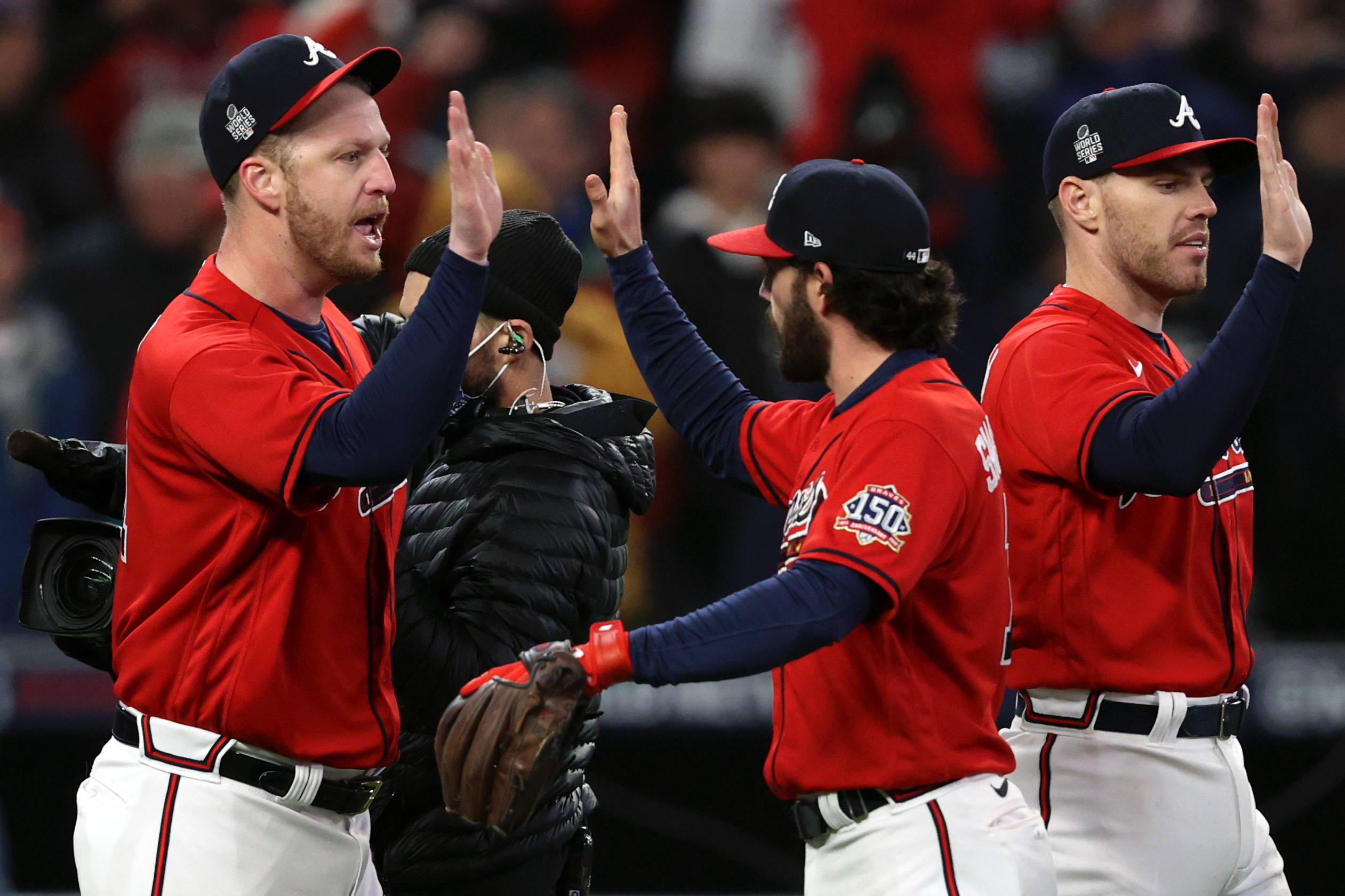 Atlanta Braves pitcher Will Smith, left, celebrate after they win Game Three against the Houston Astros.