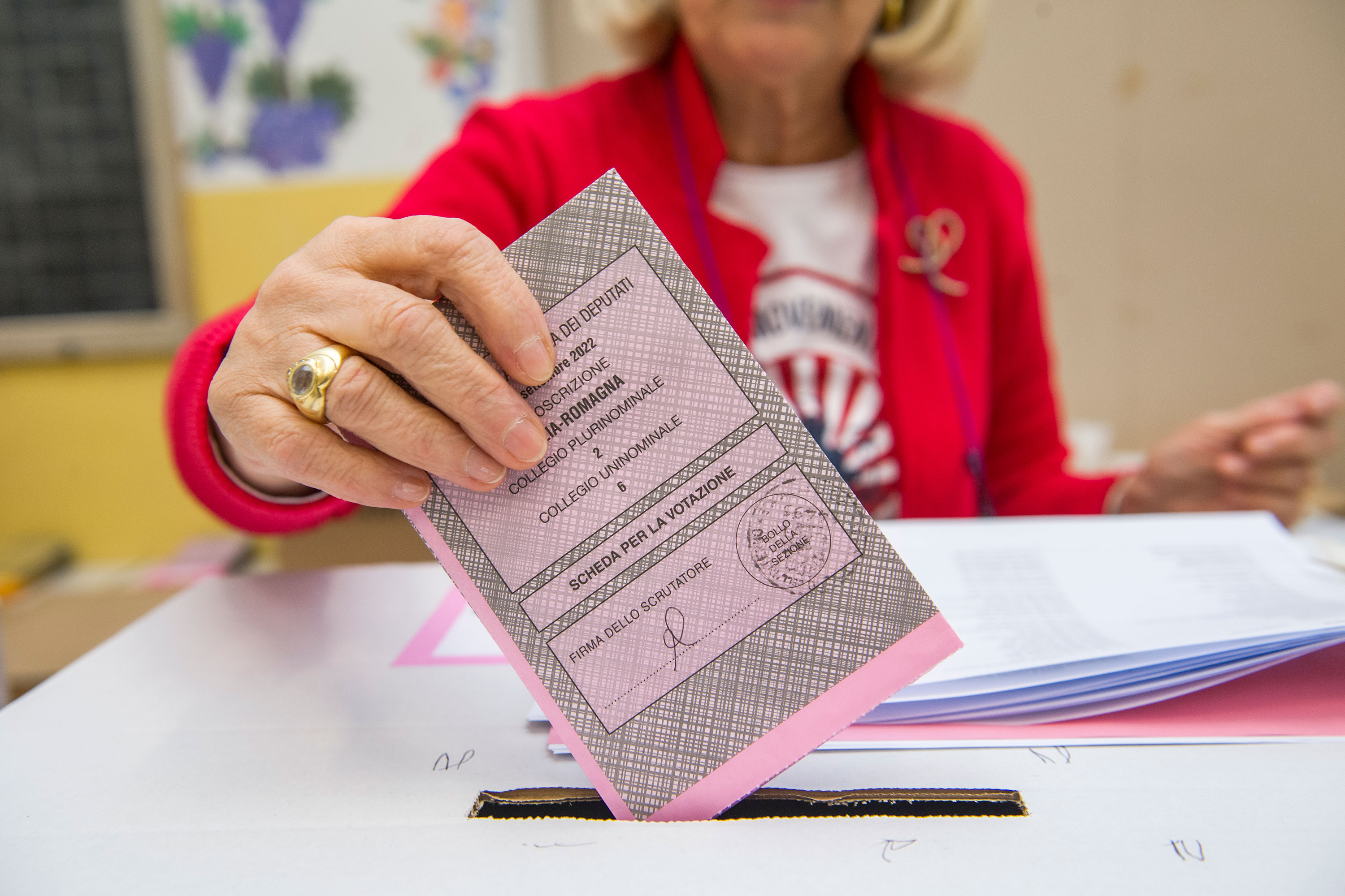 A woman places her ballot paper in the ballot box on September 25, in Bologna, Italy. 