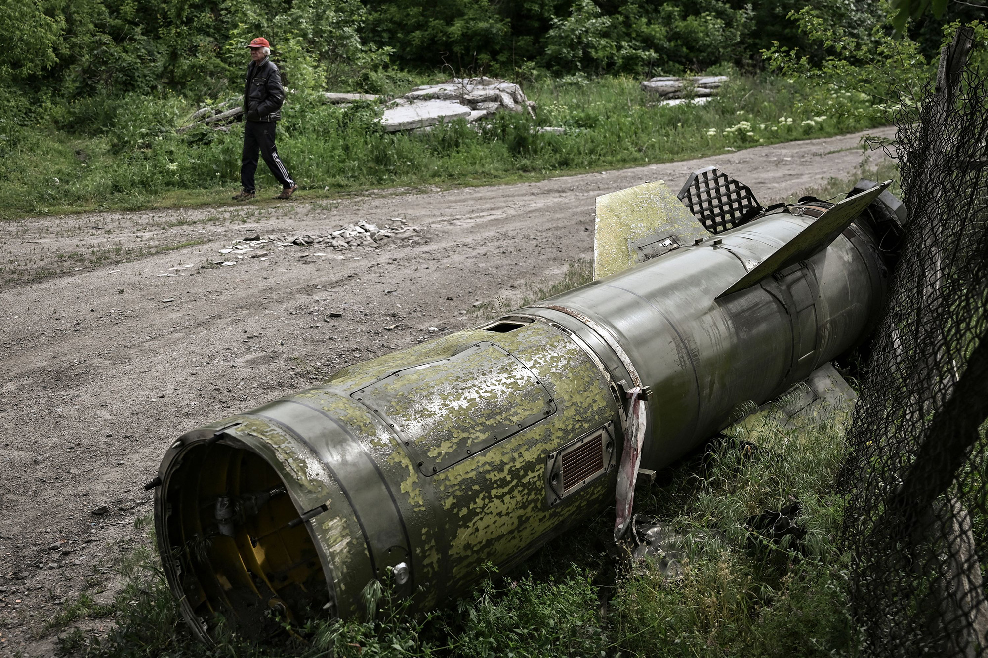A man walks near the remains of a missile in the city of Lysychansk, in eastern Ukraine, on May 26.