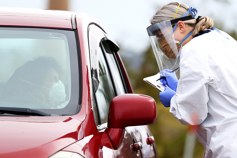 A medical professional works at a drive-thru coronavirus testing site at Cambridge Health Alliance Somerville Hospital on Tuesday, April 28, in Somerville, Massachusetts. 