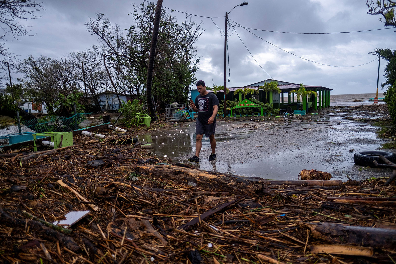 A man walks through debris in the aftermath of Hurricane Fiona in Guayanilla, Puerto Rico on September 19. 