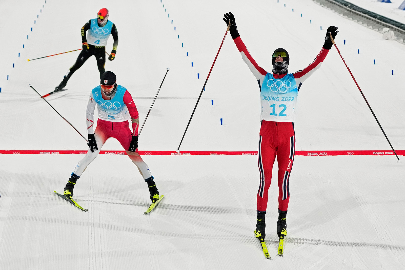 Norway's Jørgen Graabak, right, celebrates after winning the men's individual large hill/10km Nordic combined on February 15. 