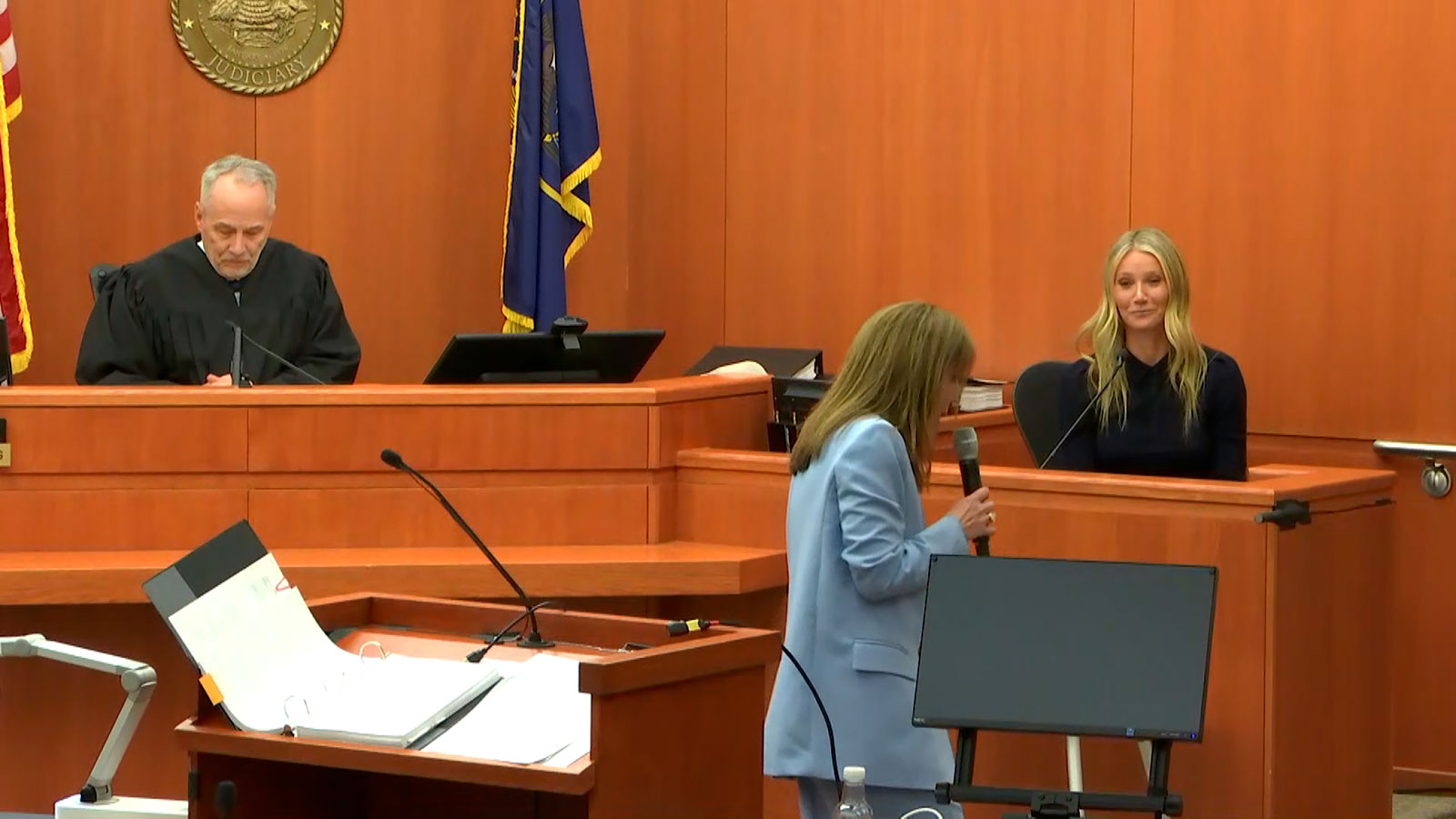 Attorney Kristin VanOrman, center, reenacts the ski crash in court on Friday.