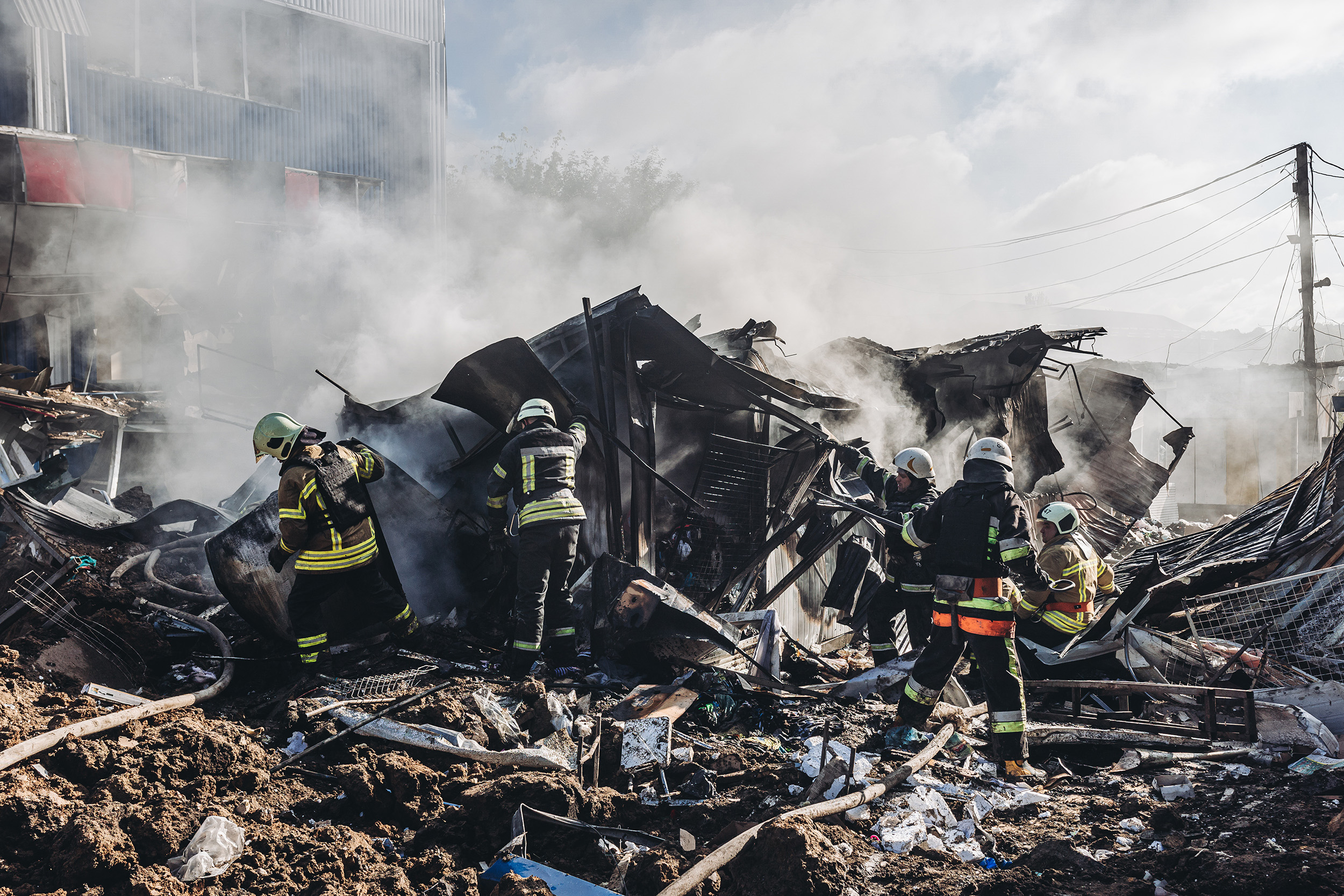 Ukrainian firefighters work at the Bakhmut market after it was shelled in the city of Bakhmut, Donetsk Oblast, Ukraine, on July 21.