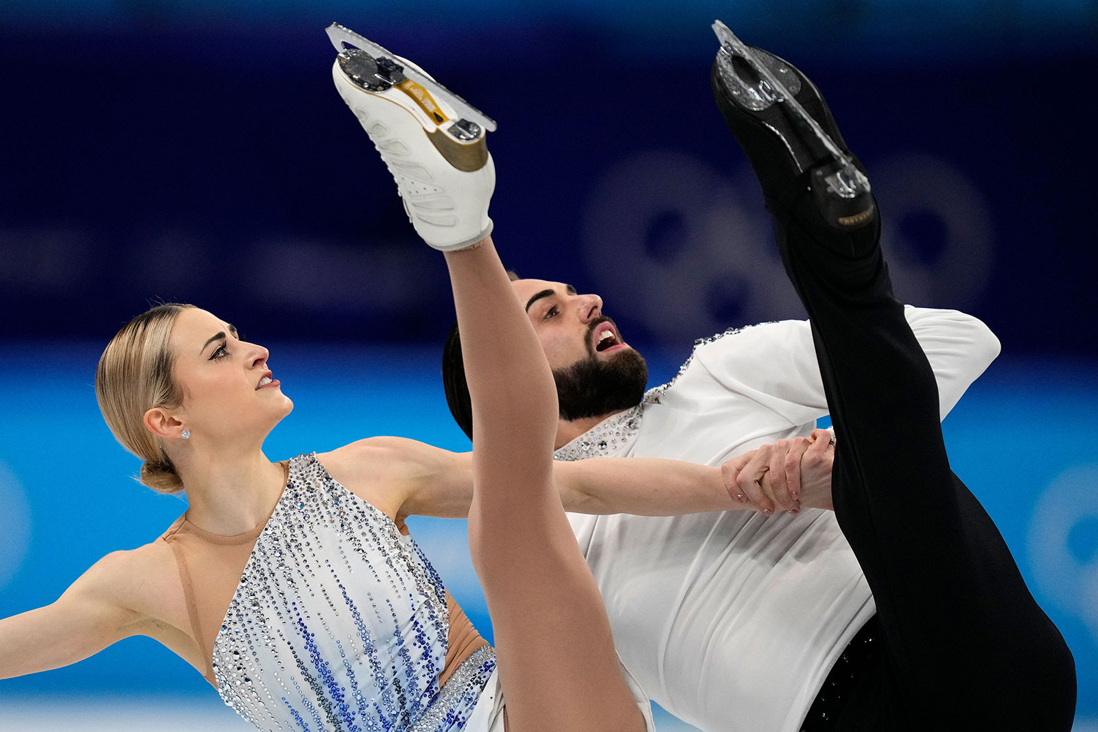 American figure skating duo Ashley Cain-Gribble and Timothy LeDuc skate in the pairs short program on February 18. LeDuc became the first openly nonbinary athlete to compete at the Winter Olympics.