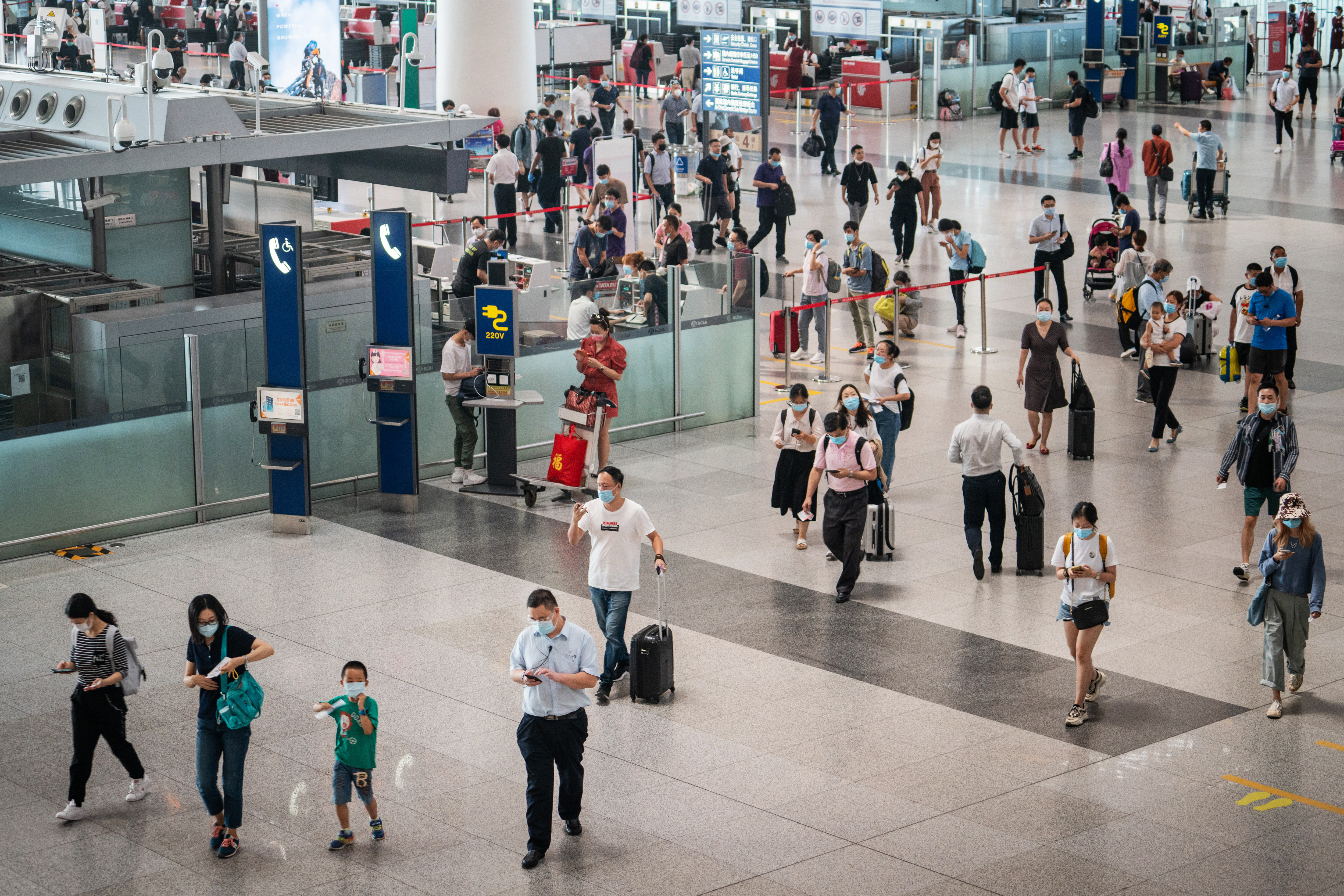 People walk through Beijing Capital International Airport in China, on August 25.