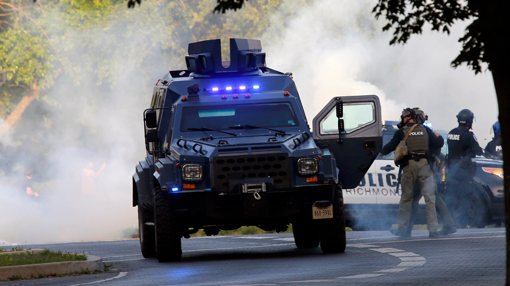 A State Police tactical vehicle is surrounded by a cloud of tear gas at the Lee Monument on Monument Avenue in Richmond, Virginia, on Monday, June 1.