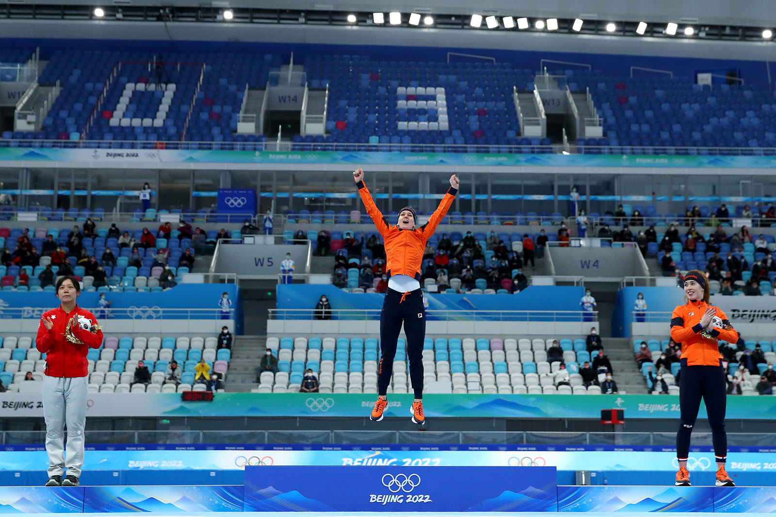 Dutch speed skater Ireen Wüst, center, celebrates on the podium following her win in the women's 1,500m on February 7.