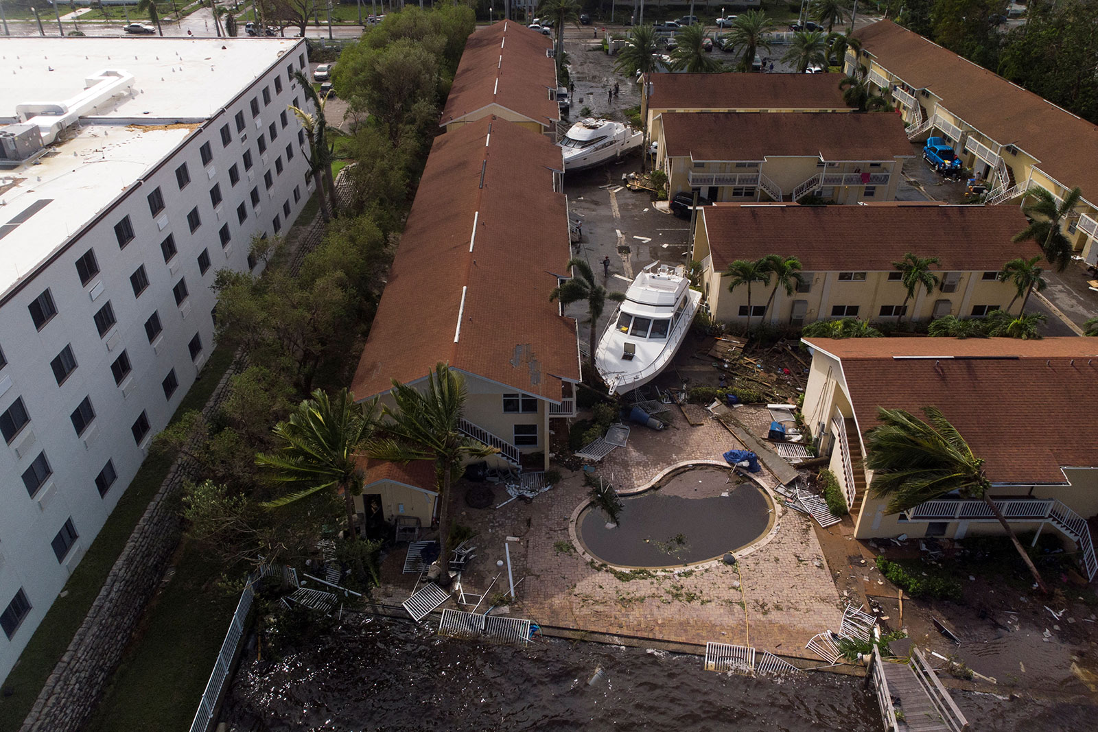 Damaged boats are seen between downtown condominiums in Fort Myers, Florida on Thursday. 