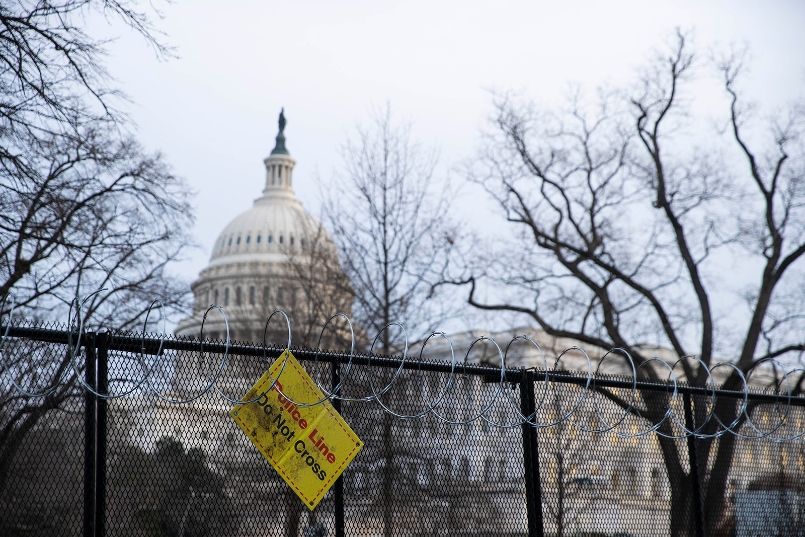 A sign reading 'Police Line Do Not Cross' hangs from the fenced perimeter surrounding the US Capitol in Washington, DC, on February 10.