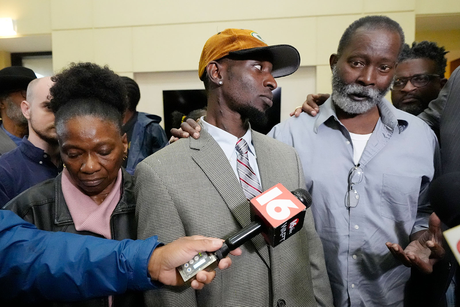 Melvin Jenkins, right, stands with his son, Michael Jenkins, while commenting on the sentencing of six former Mississippi law enforcement officers on Wednesday in Brandon, Mississippi.