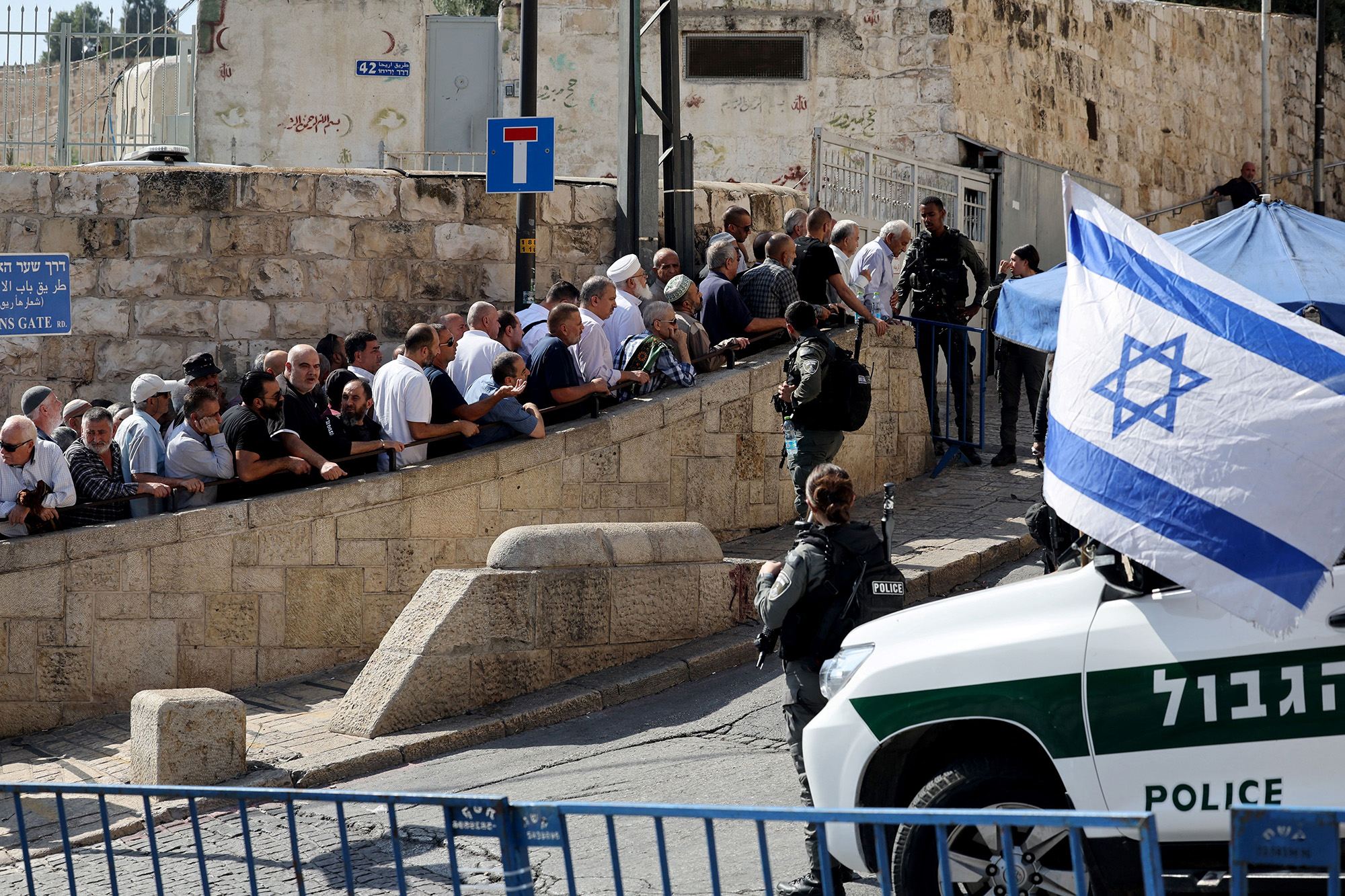 Israeli border police watch as Muslim worshippers arrive at the Lion's Gate to make their way to the al-Aqsa Mosque compound for the Friday noon prayer in East Jerusalem on November 3.