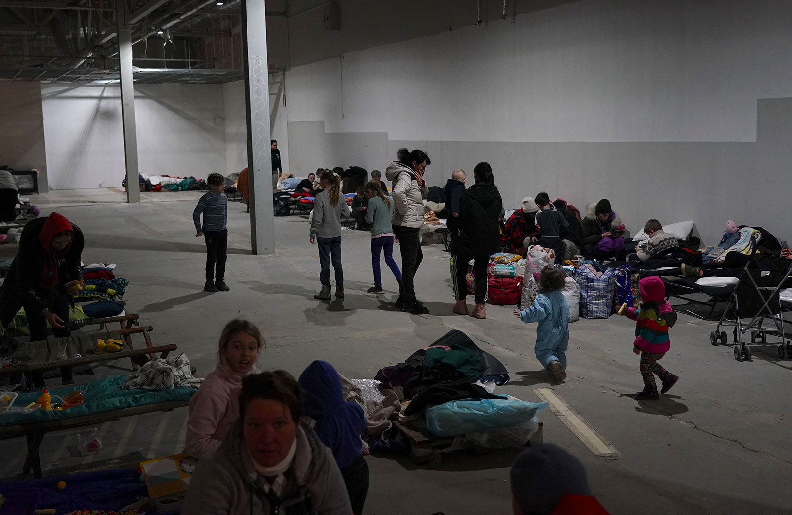 Ukrainian refugees wait in an empty shopping center to be transported from Przemysl, Poland, on March 4.