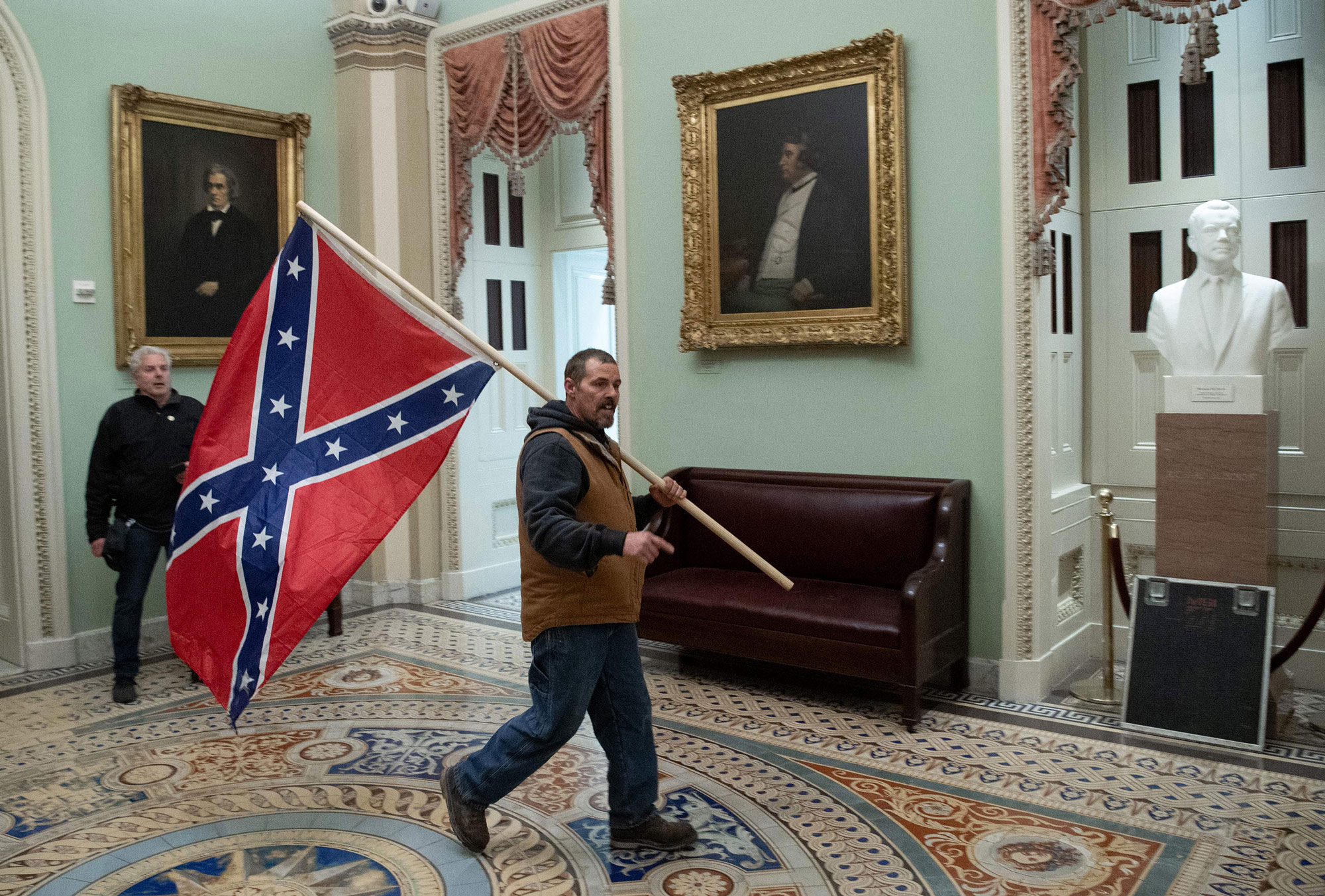  Kevin Seefried carries a confederate flag in the US Capitol Rotunda on January 6 in Washington, DC. 