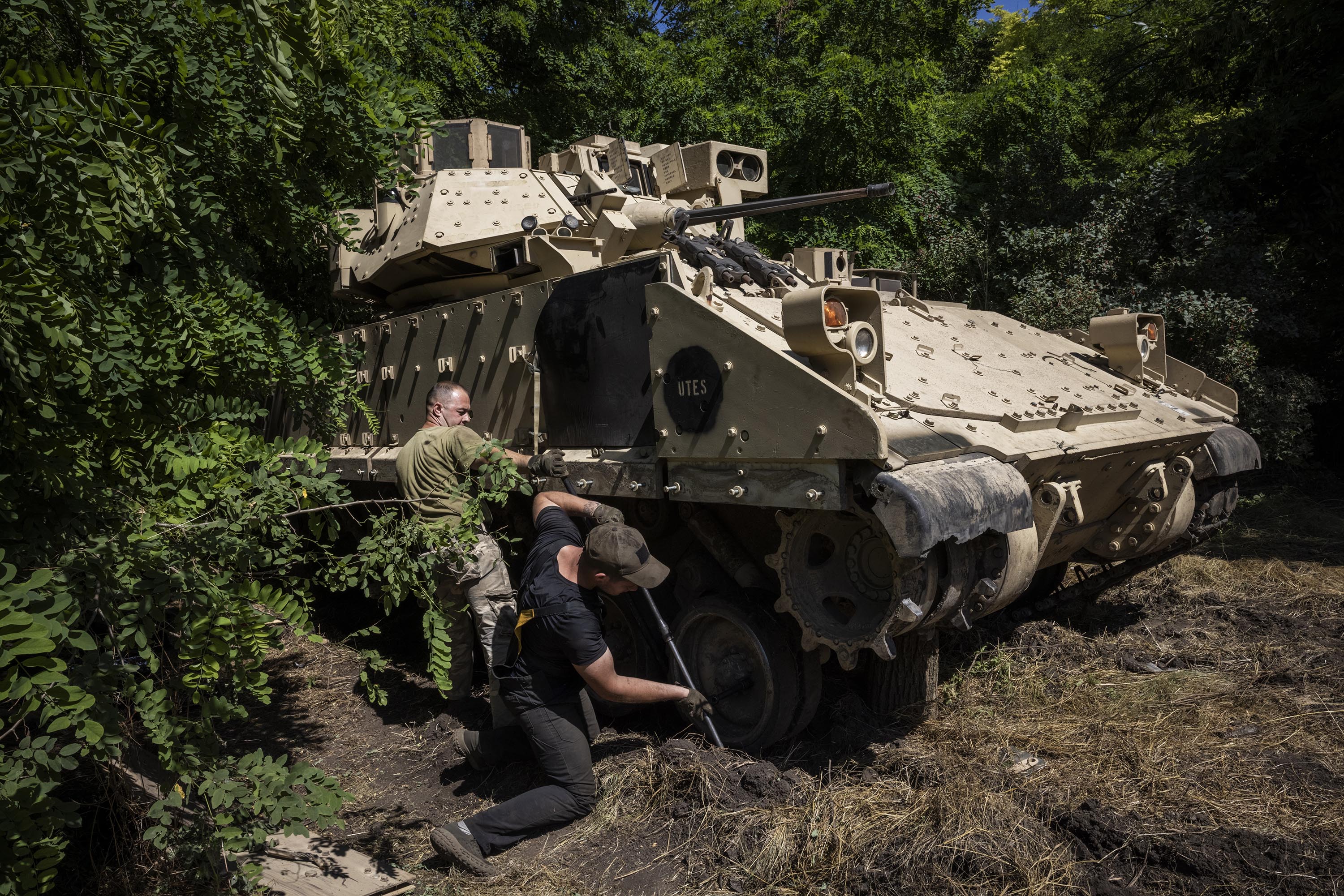 Soldiers and mechanics from Ukraine's 47th Mechanized Brigade work on the tracks of a US Bradley Fighting Vehicle in Ukraine's Zaporizhzhia Region, on July 13.