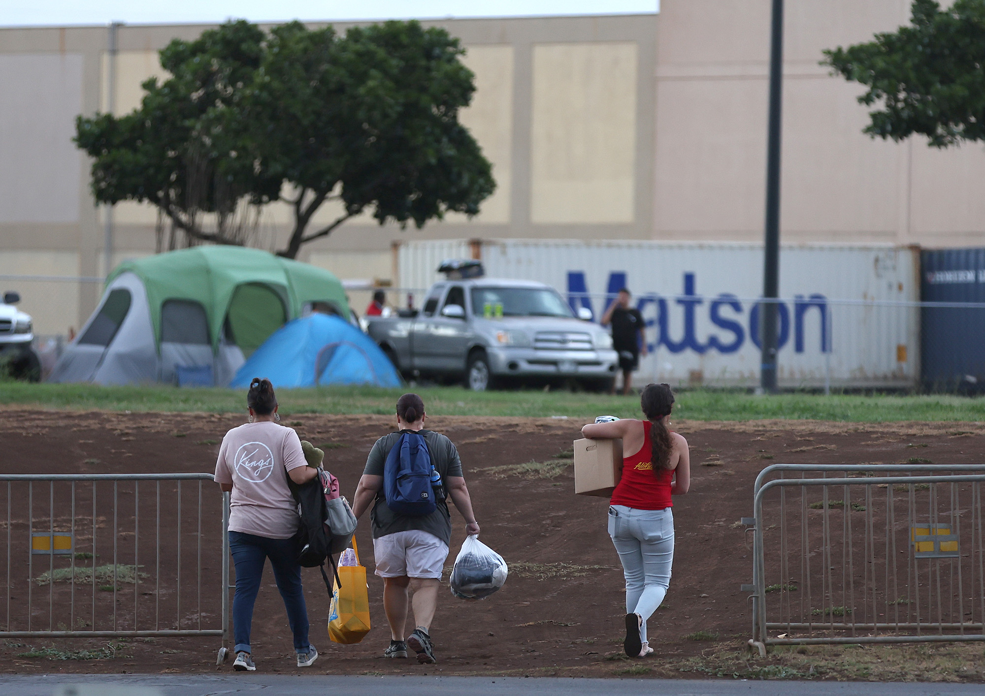 Volunteers with King's Cathedral Maui bring supplies to a displaced family that is camping on church property on August 10, in Kahului, Hawaii.