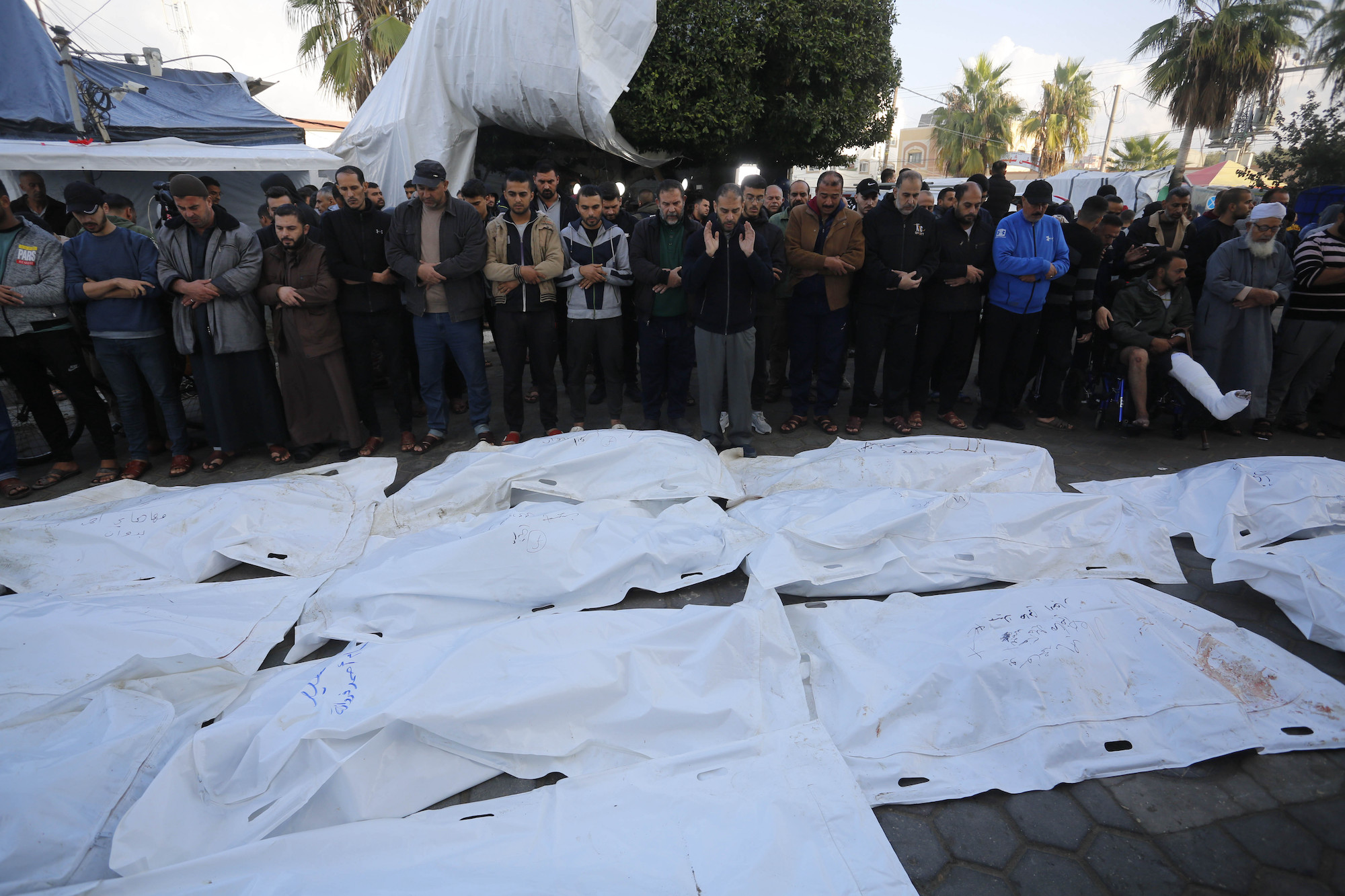Palestinians perform funeral prayer for people killed during Israeli airstrikes in Deir Al-Balah, Gaza ,on Wednesday.