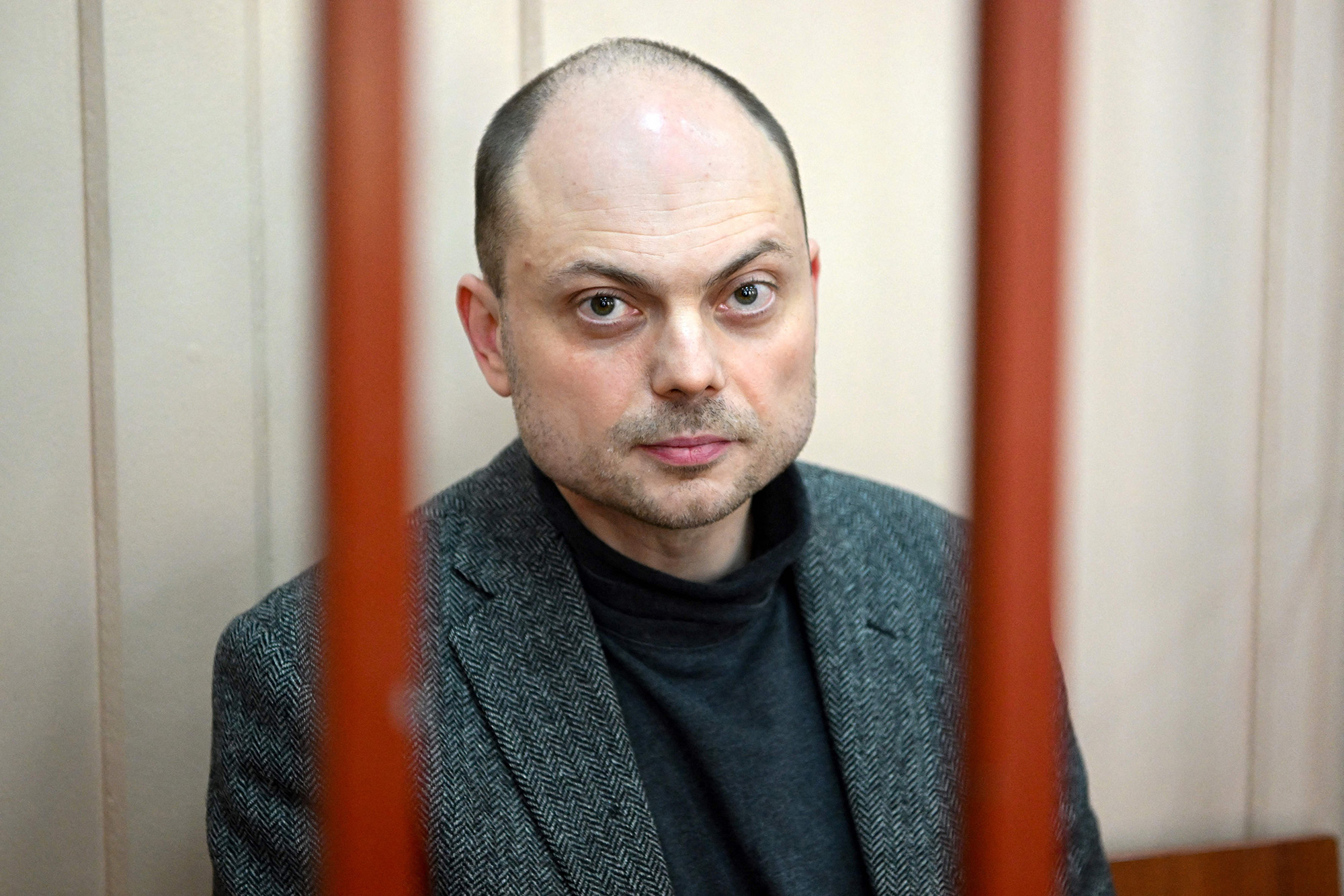 Russian opposition activist Vladimir Kara-Murza sits on a bench inside a defendants' cage during a hearing at the Basmanny court in Moscow, Russia, on October 10, 2022.