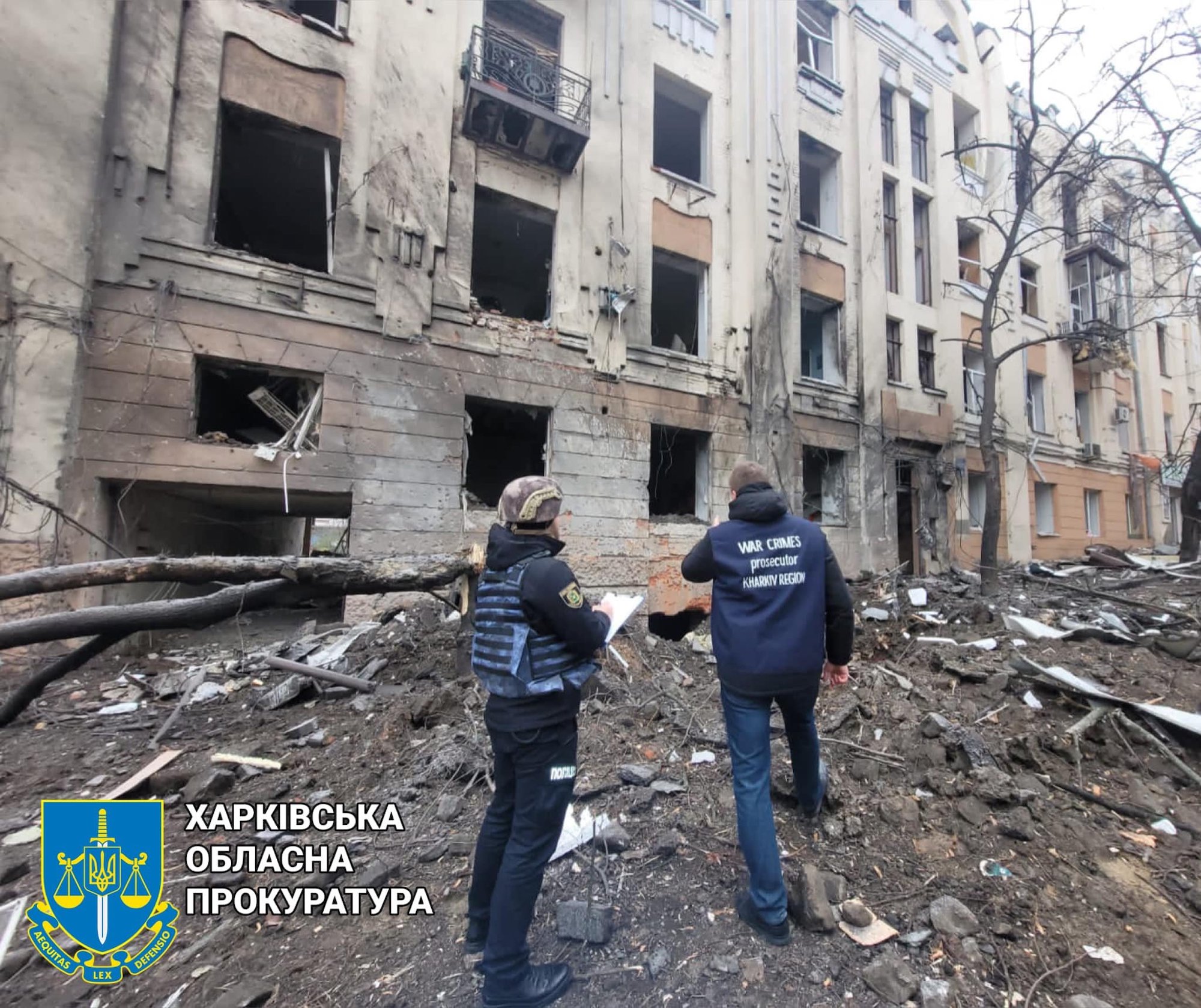 Two Ukrainian officials investigate the site of Russian shelling on Sunday.