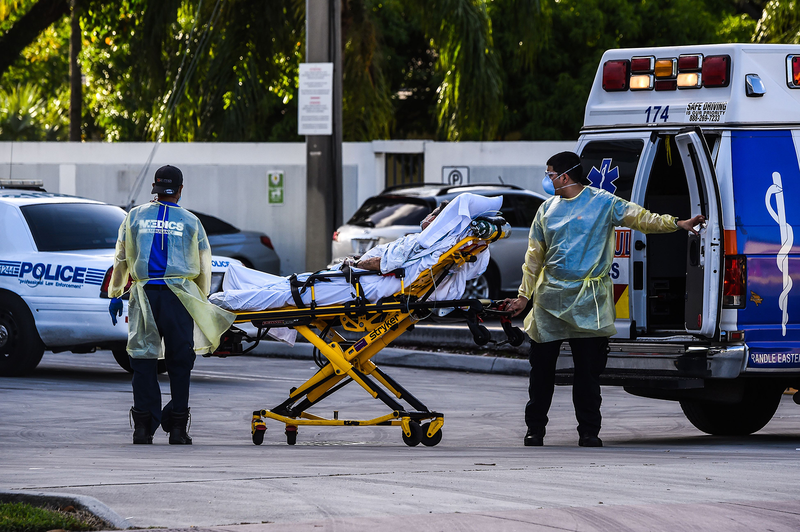 Medics transfer a patient on a stretcher from an ambulance outside Coral Gables Hospital near Miami on July 30. 