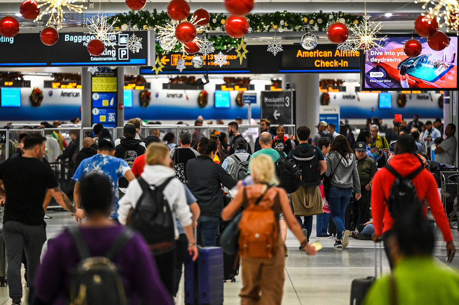 Travelers walk through Miami International Airport in Florida, on December 23. 