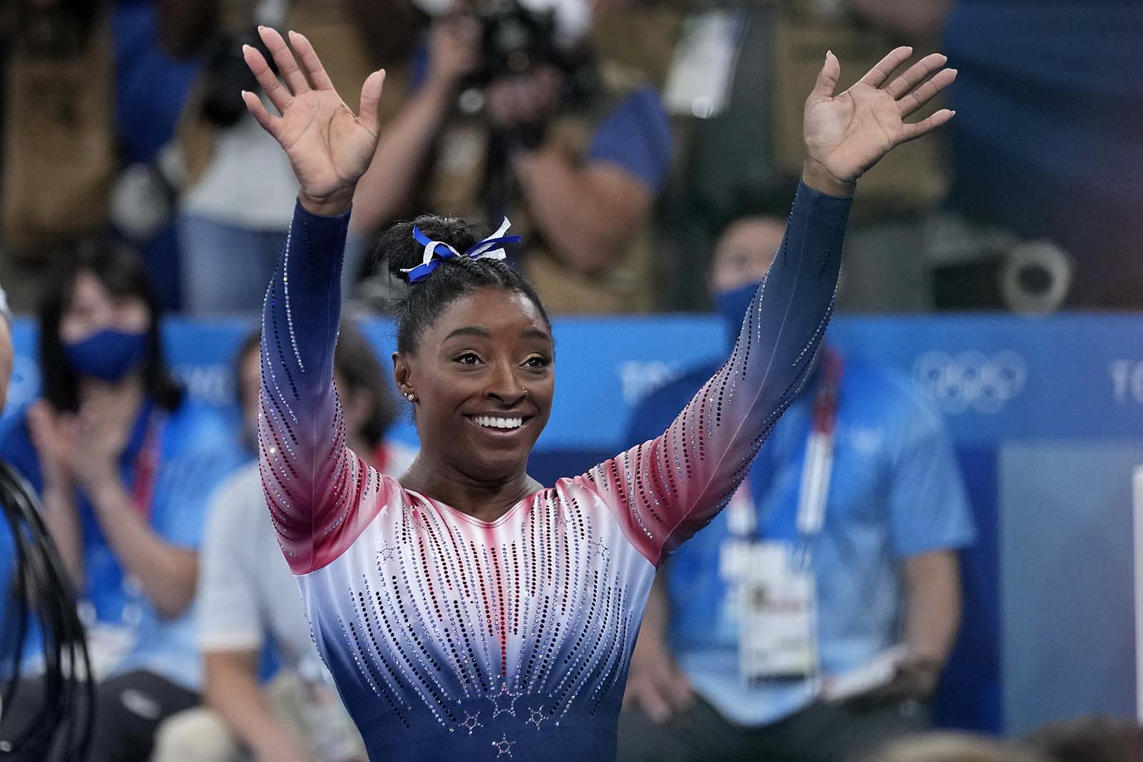 Simone Biles waves after her bronze-winning performance on the balance beam on Tuesday. 