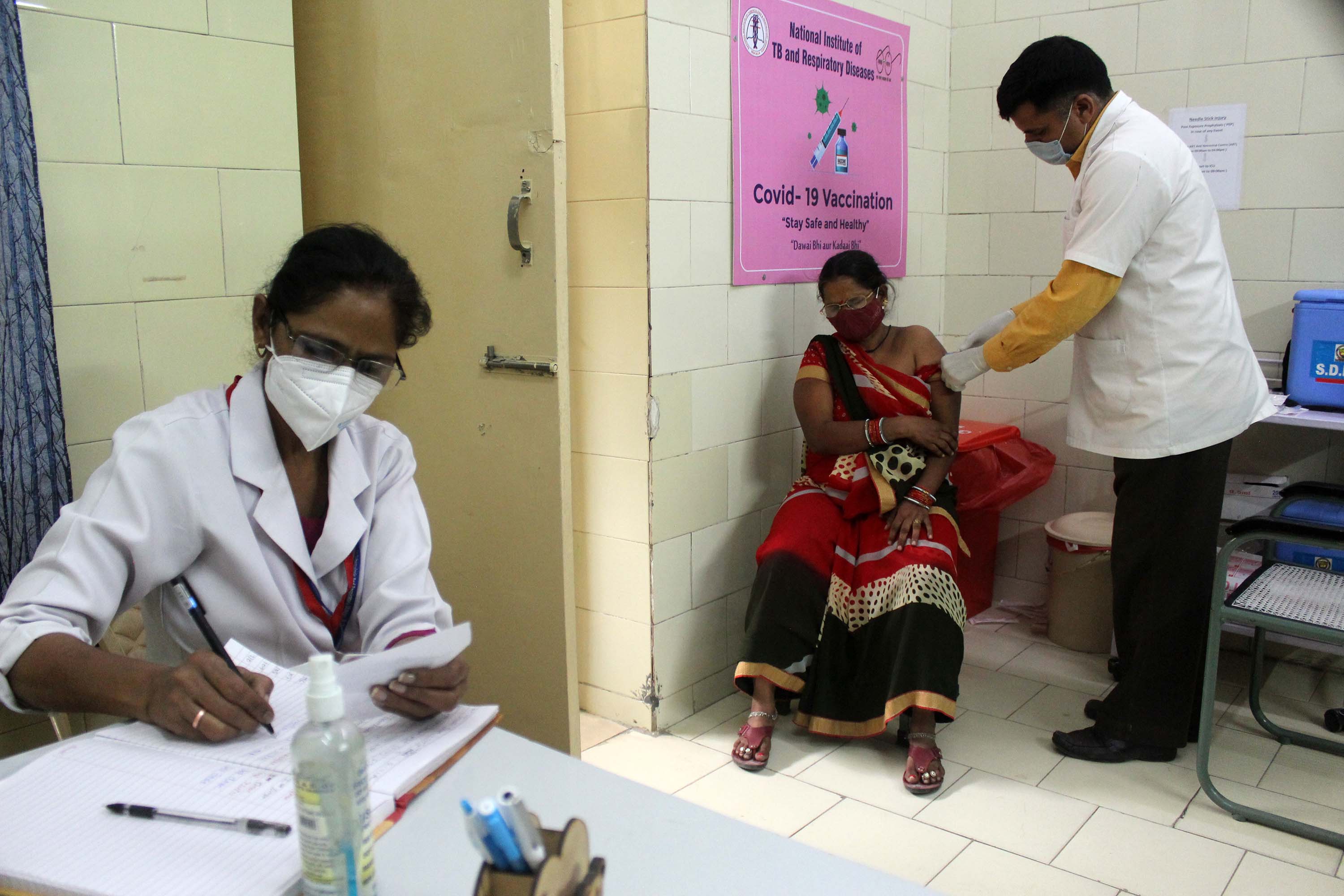 A woman receives a dose of the COVISHIELD coronavirus vaccine, manufactured by India's Serum Institute, at a government hospital in New Delhi, on April 9. 