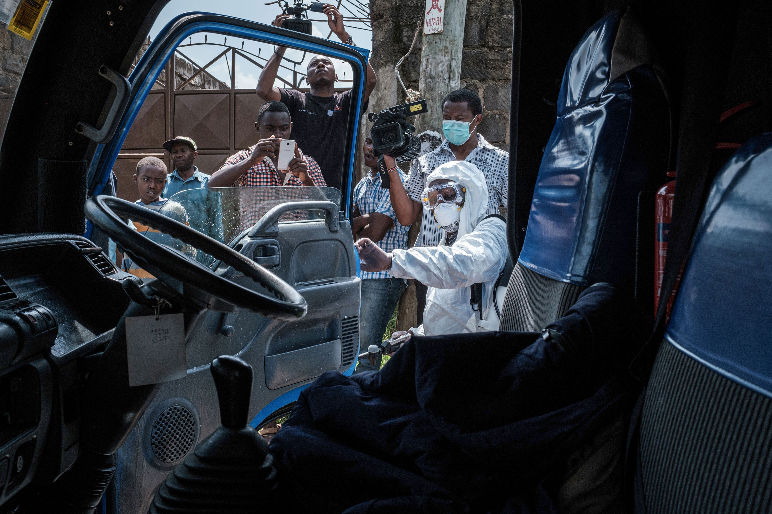 A health worker wearing protective gear in Ongata Rongai, Kenya, disinfects the minibus on March 14 in which the first Kenyan patient of the COVID-19 travelled.
