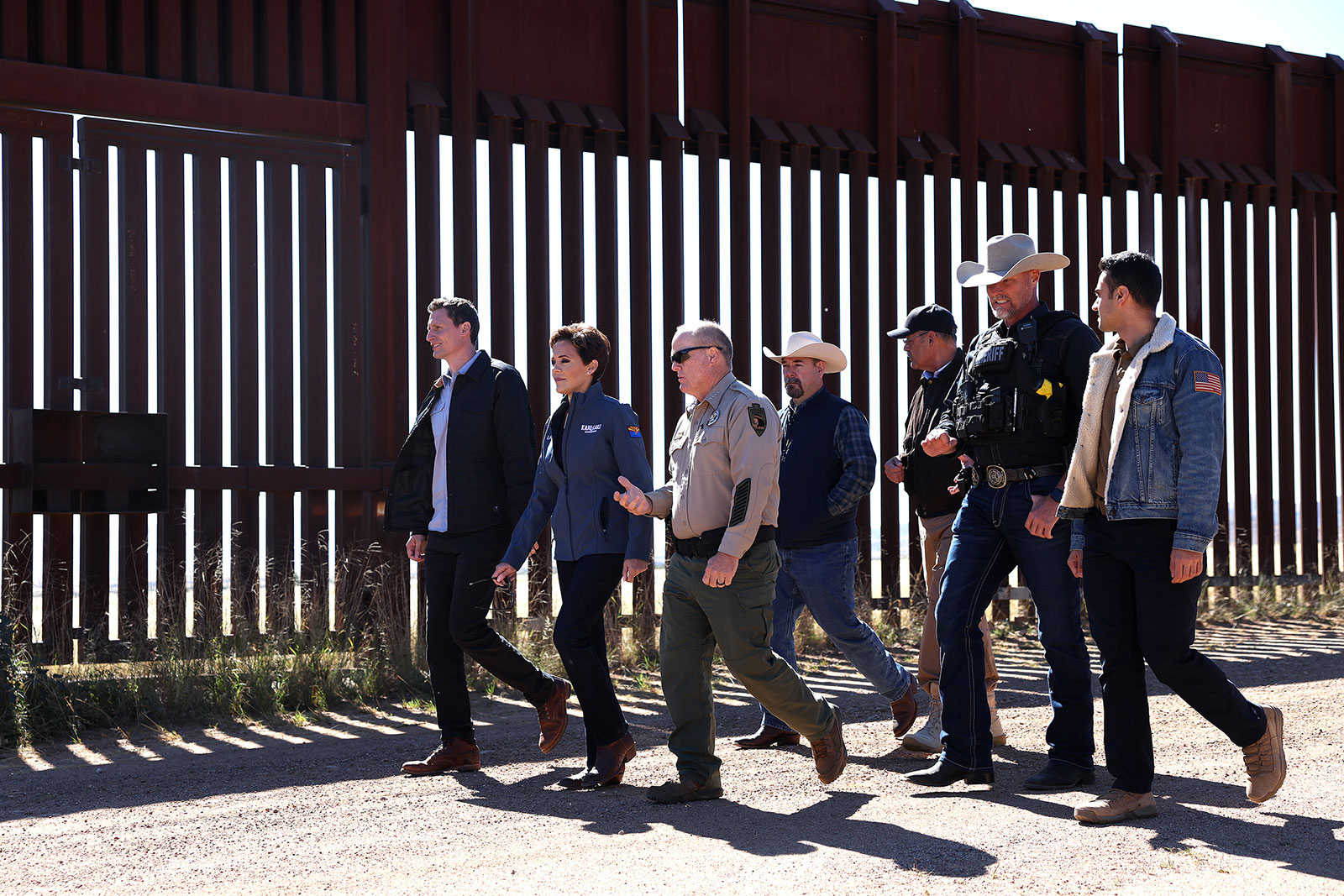Arizona Republican Gubernatorial candidate Kari Lake, center, and Republican Senate candidate Blake Masters walk with Cochise County Sheriff Mark Dannels during a tour of the US-Mexico border on November 4, in Sierra Vista, Arizona. 