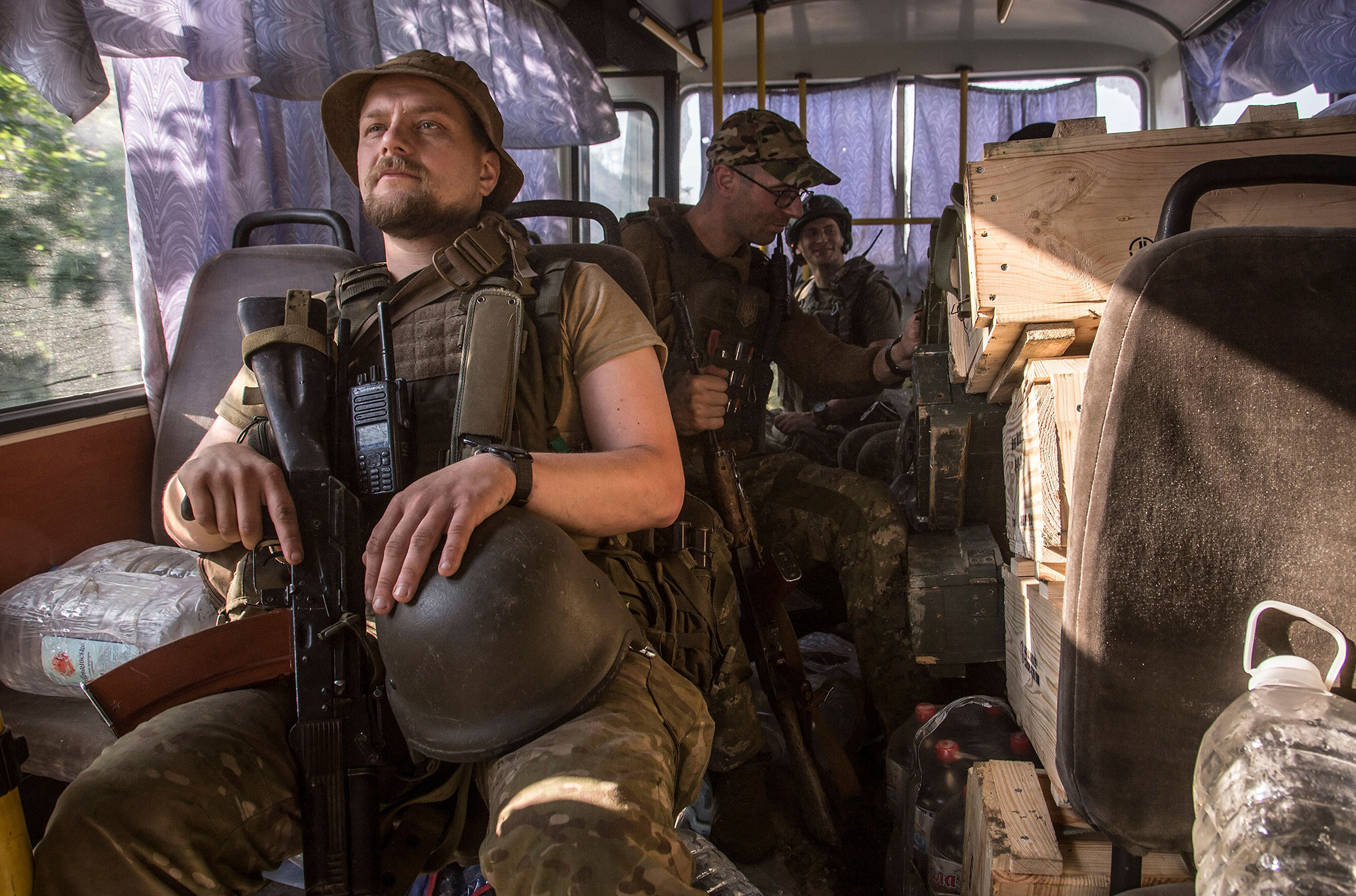 Ukrainian servicemen ride a bus to their positions in the Luhansk area, Ukraine, on June 19.