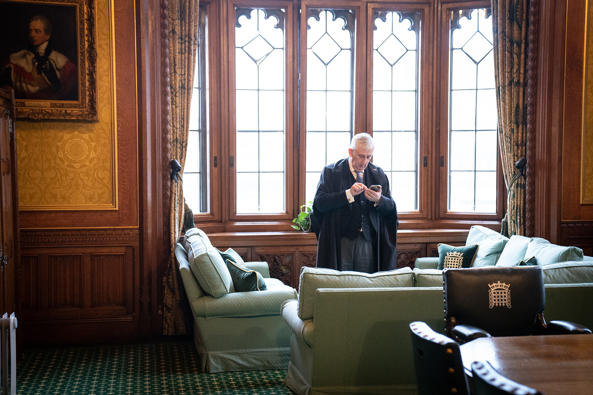 Speaker of the House of Commons Sir Lindsay Hoyle uses a mobile phone in his office in the Palace of Westminster, London, on February 21, 2022. Sir Hoyle is one of the 287 members of the British Parliament that Russia has sanctioned.