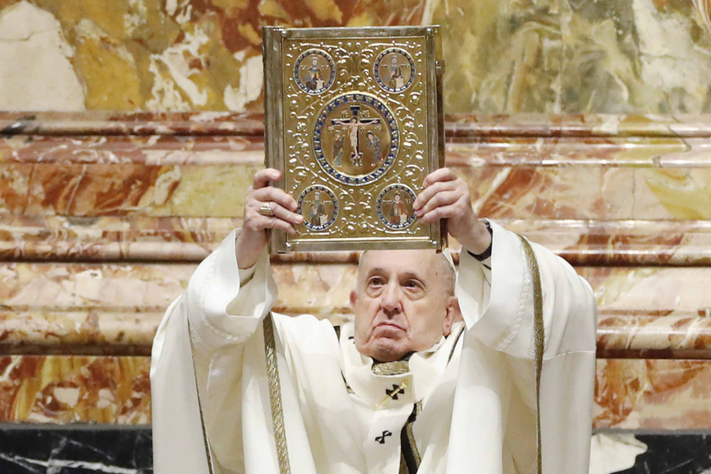 Pope Francis holds the Holy Book of Prayers as he celebrates Mass for the Epiphany on January 6, at St. Peter's Basilica in the Vatican. 