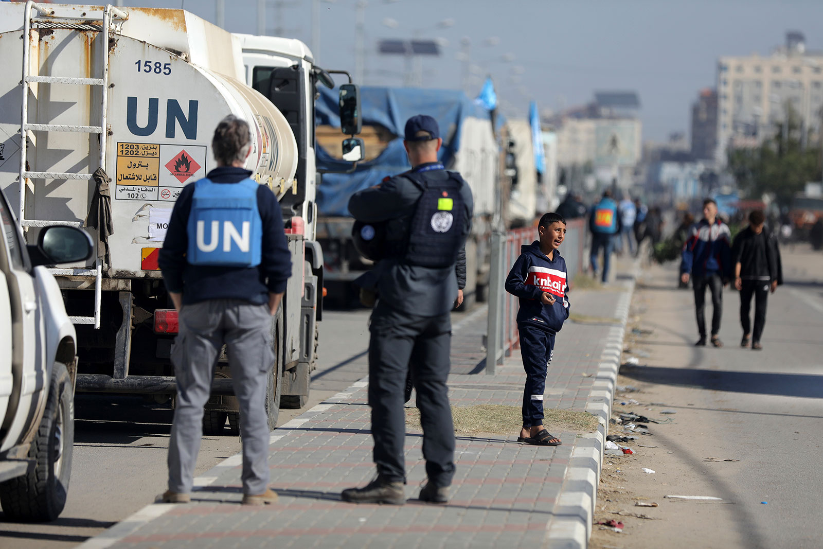 Vehicles transporting humanitarian aid wait in the Bureij camp in central Gaza on November 30.