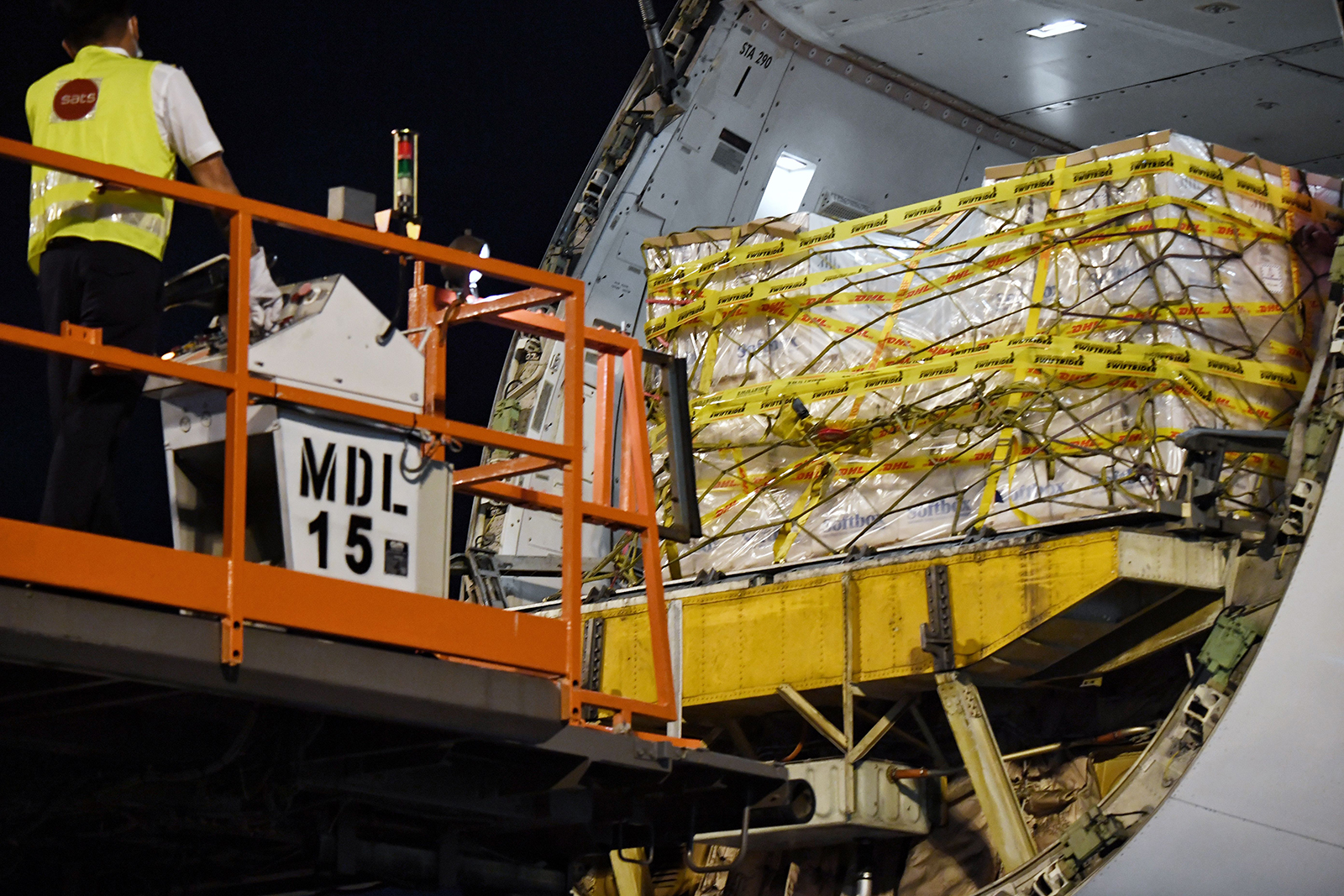 A shipment of the Covid-19 vaccine is unloaded from a Singapore Airlines Boeing 747 cargo plane at the Changi Airport in Singapore, on December 21.